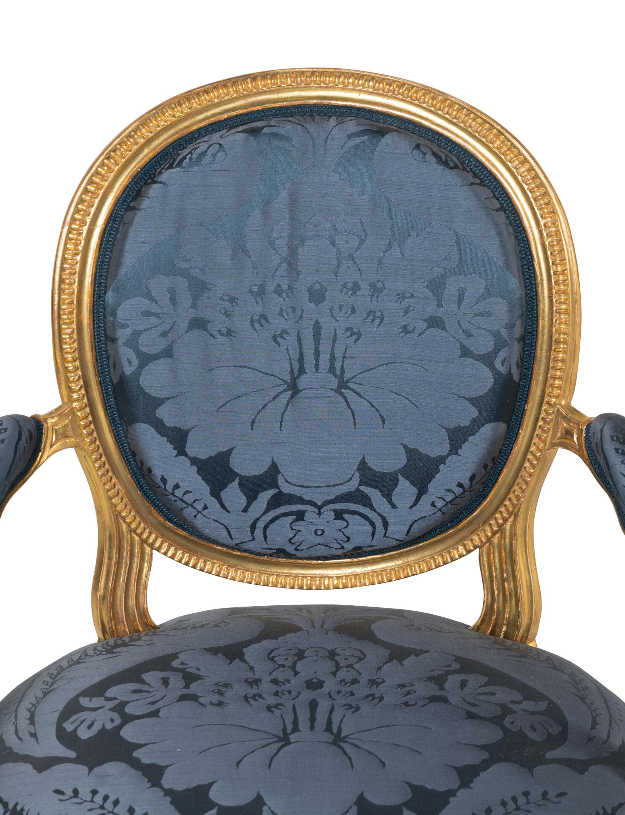 A Set of Six George III Carved Giltwood Armchairs