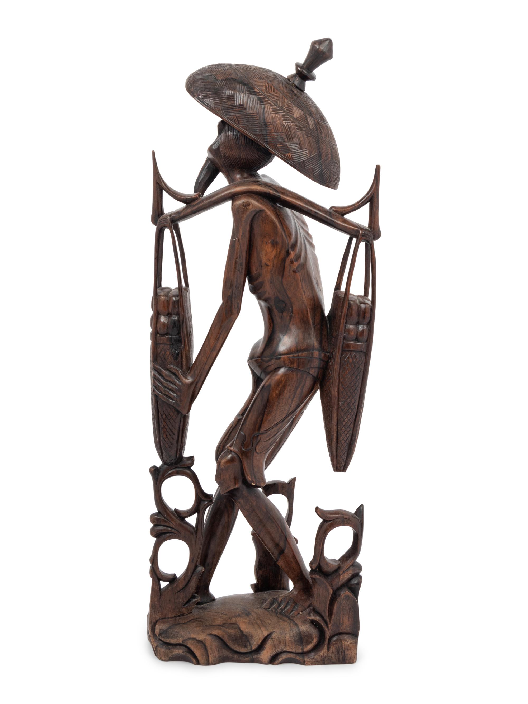 A Carved Wood Figure of a Water Carrier