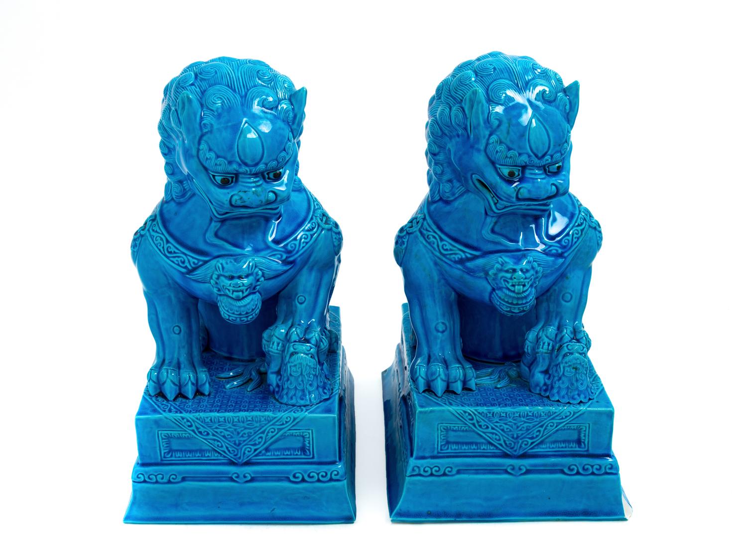 A Pair of Chinese Turquoise Glazed Porcelain Figures of Fu Lions