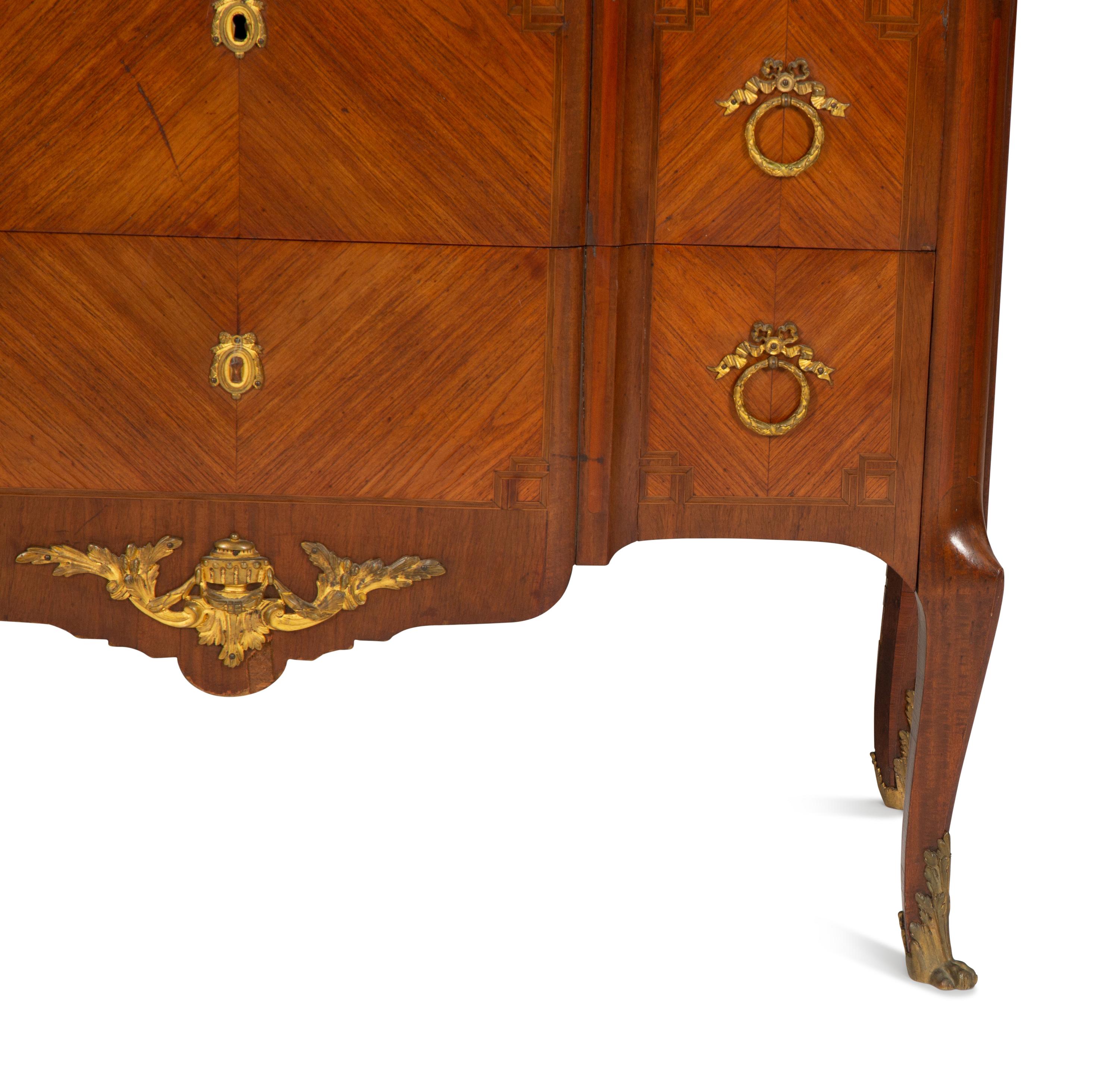 A French Gilt Metal Mounted Mahogany and Kingwood Marquetry Marble-Top Commode