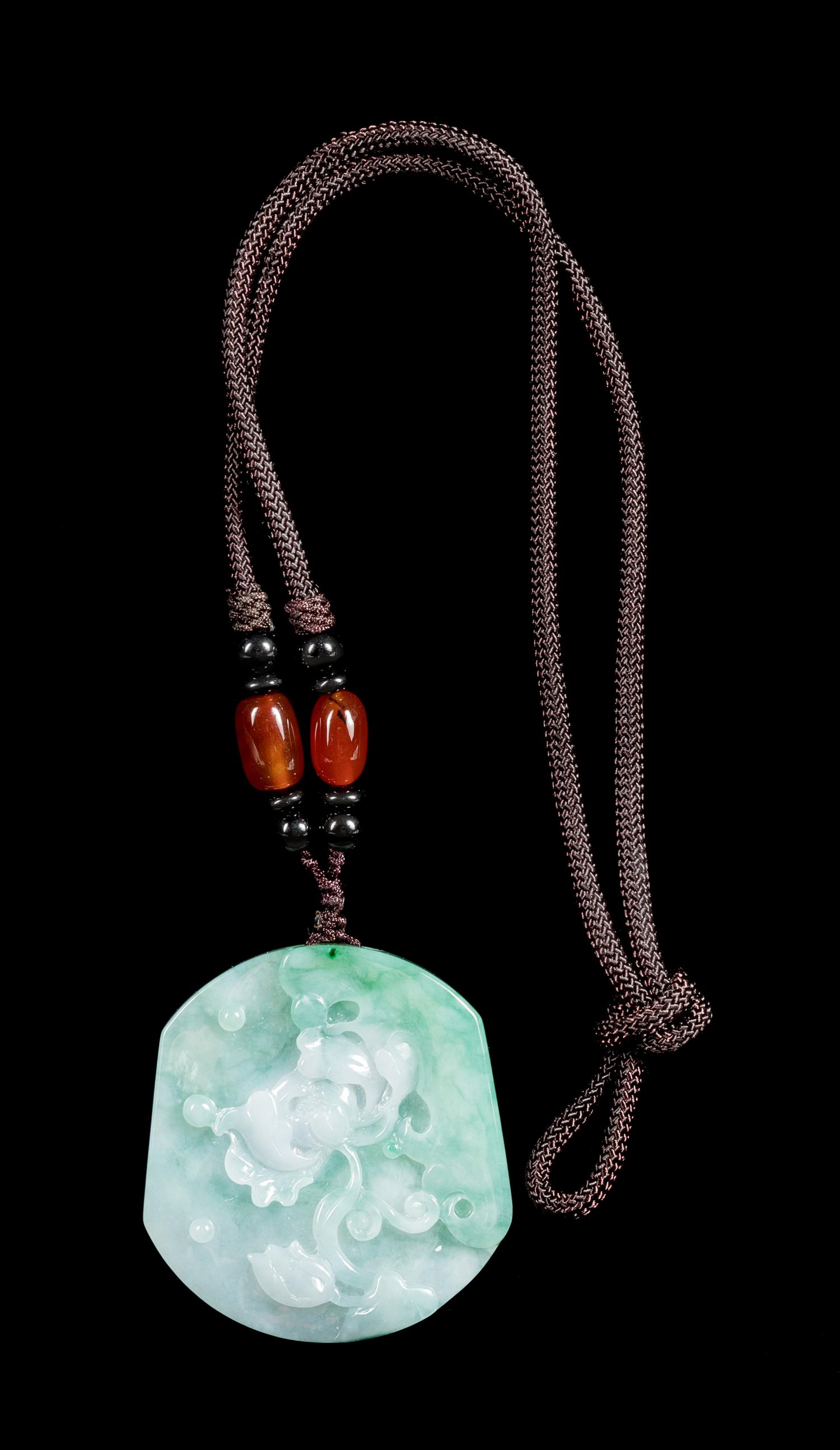 A Celadon and White Jadeite 'Lotus' Pendant Length 2 inches. — 20TH CENTURY