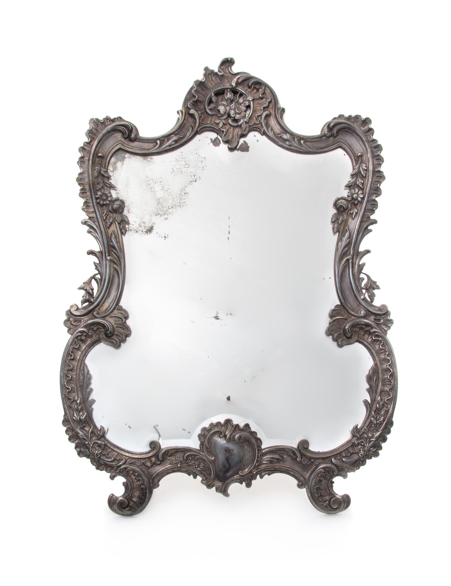 A French Silver Dressing Mirror, 19th/20th Century, of cartouche form, with an easel.