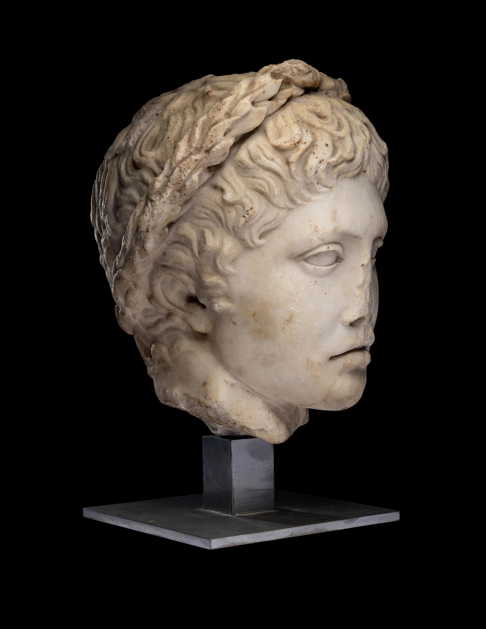 A Roman Marble Head of a Youth Wearing a Laurel Wreath