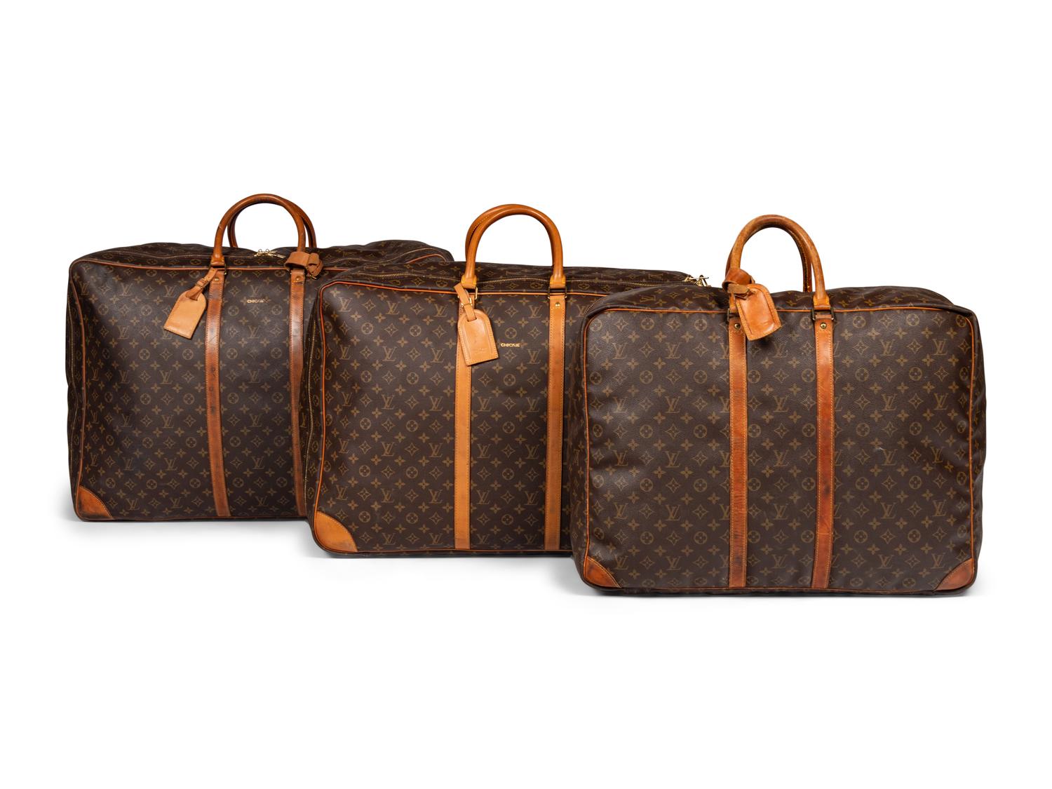 A Group of Three Louis Vuitton Soft-Sided Suitcases, 20th Century