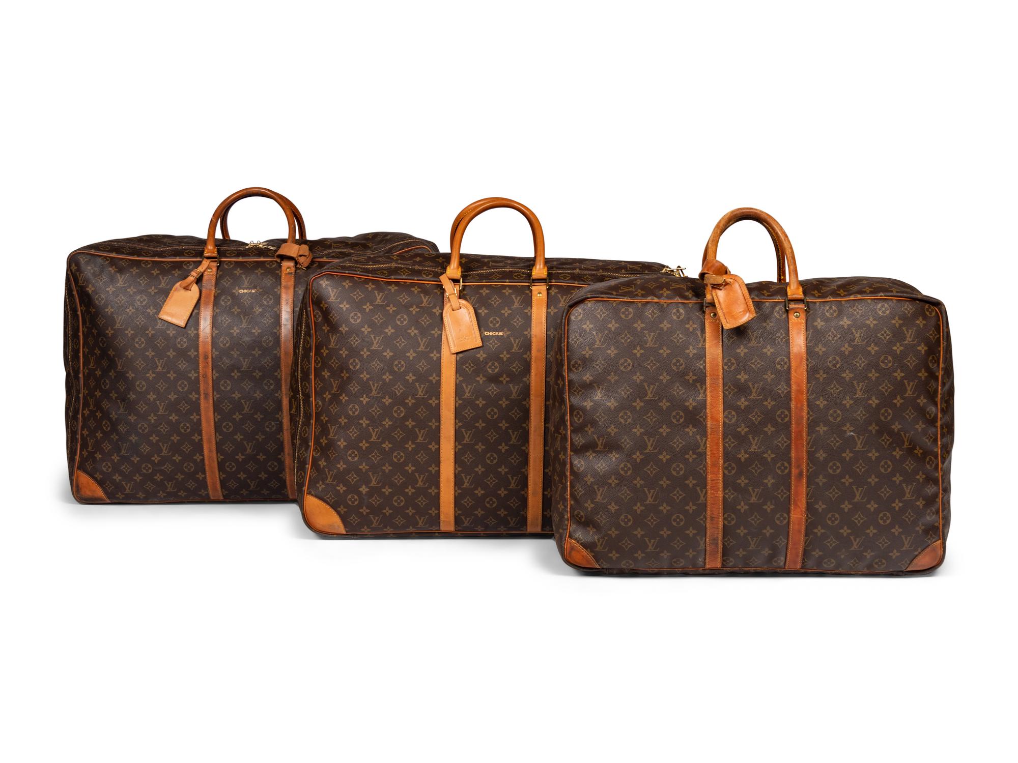 A Group of Three Louis Vuitton Soft-Sided Suitcases, 20th Century