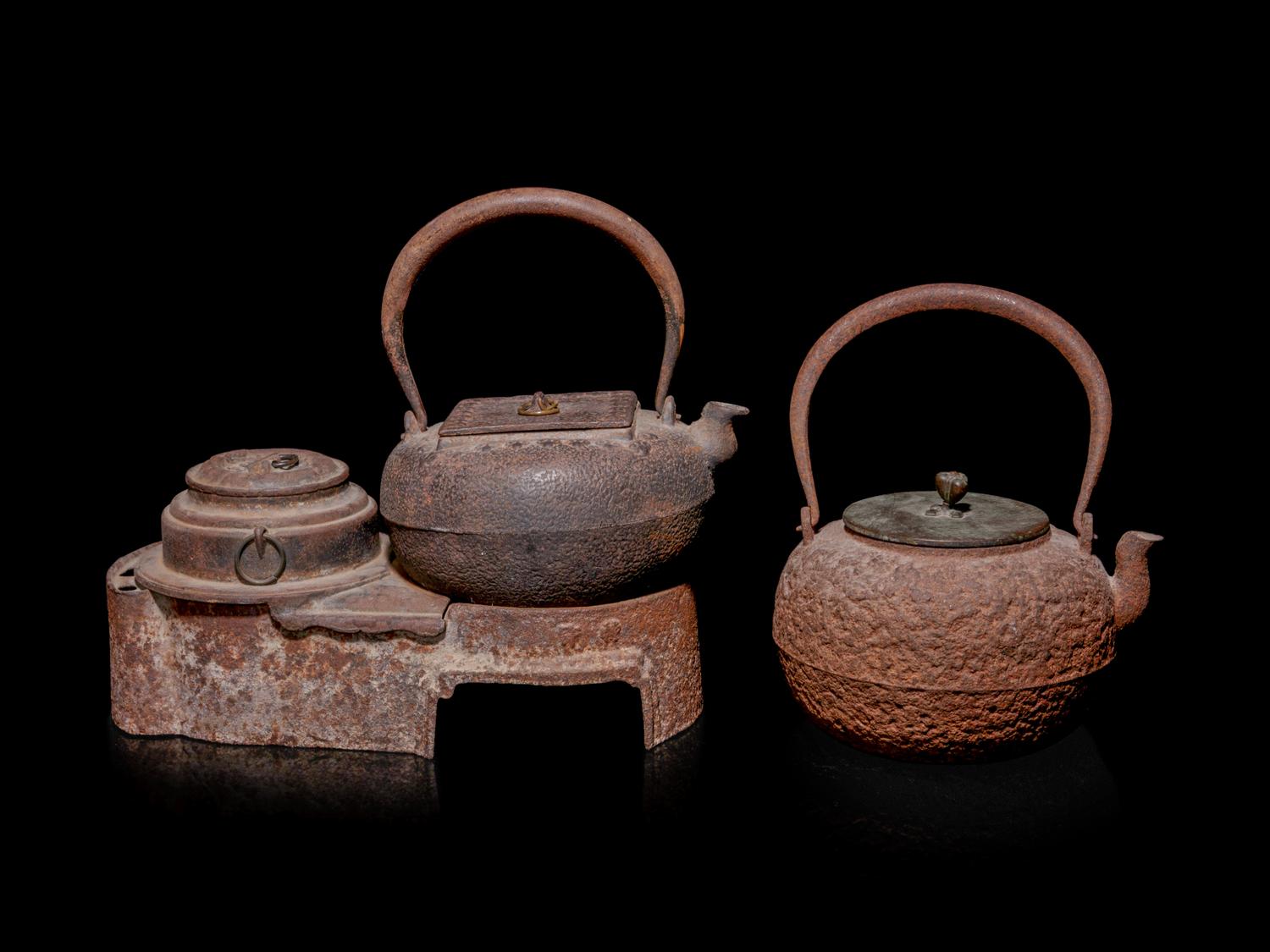 Seven Japanese Cast Iron Teapots, Tetsubin, and Burner