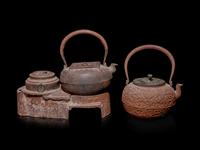 Seven Japanese Cast Iron Teapots, Tetsubin, and Burner