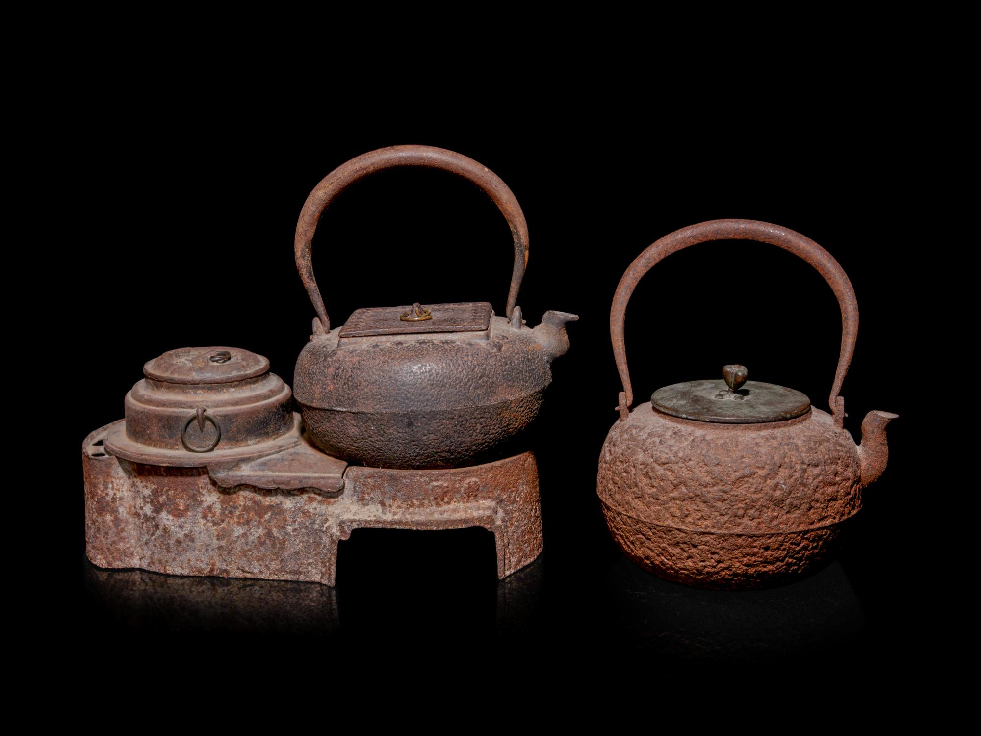 Seven Japanese Cast Iron Teapots, Tetsubin, and Burner