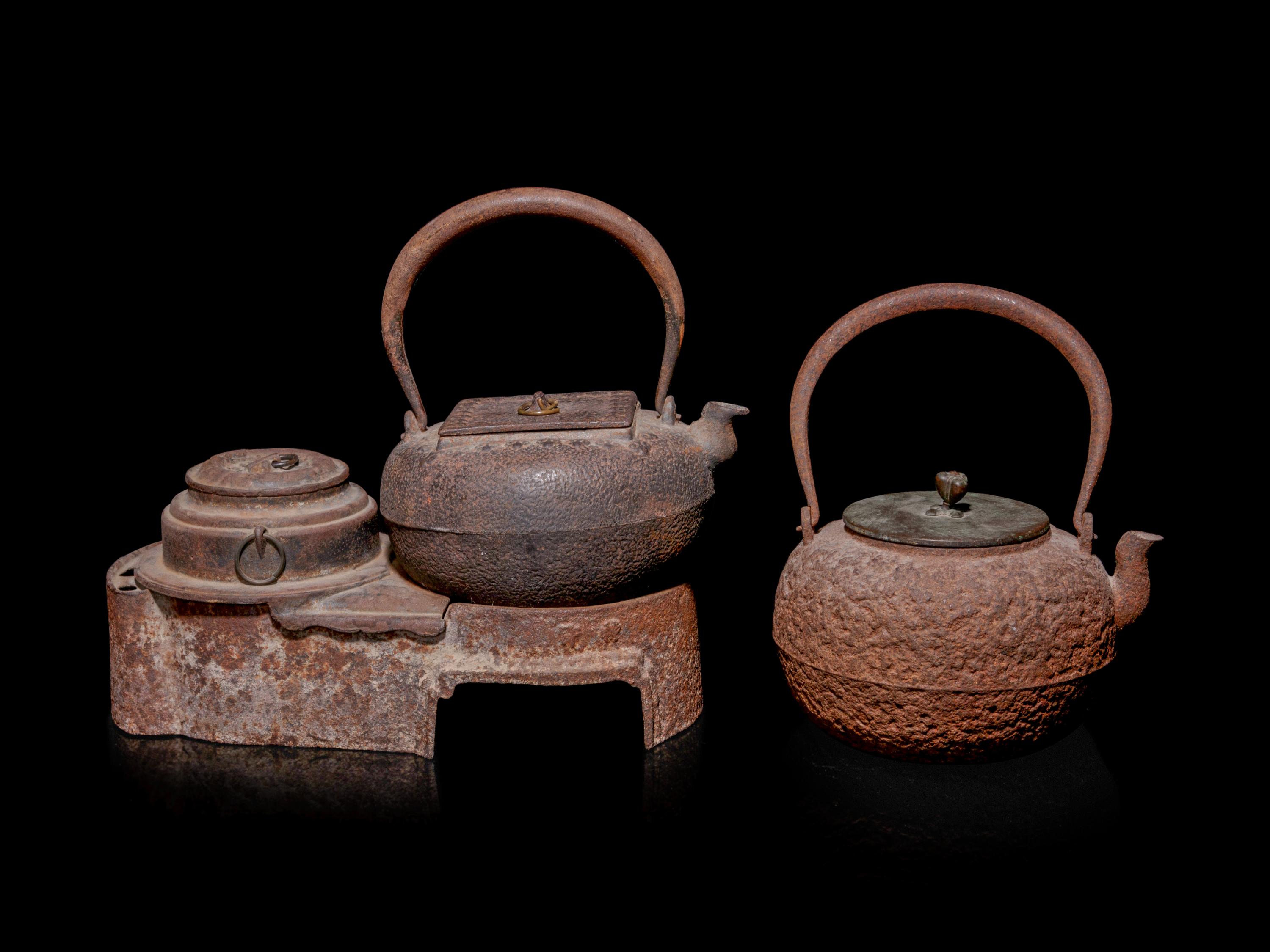 Seven Japanese Cast Iron Teapots, Tetsubin, and Burner