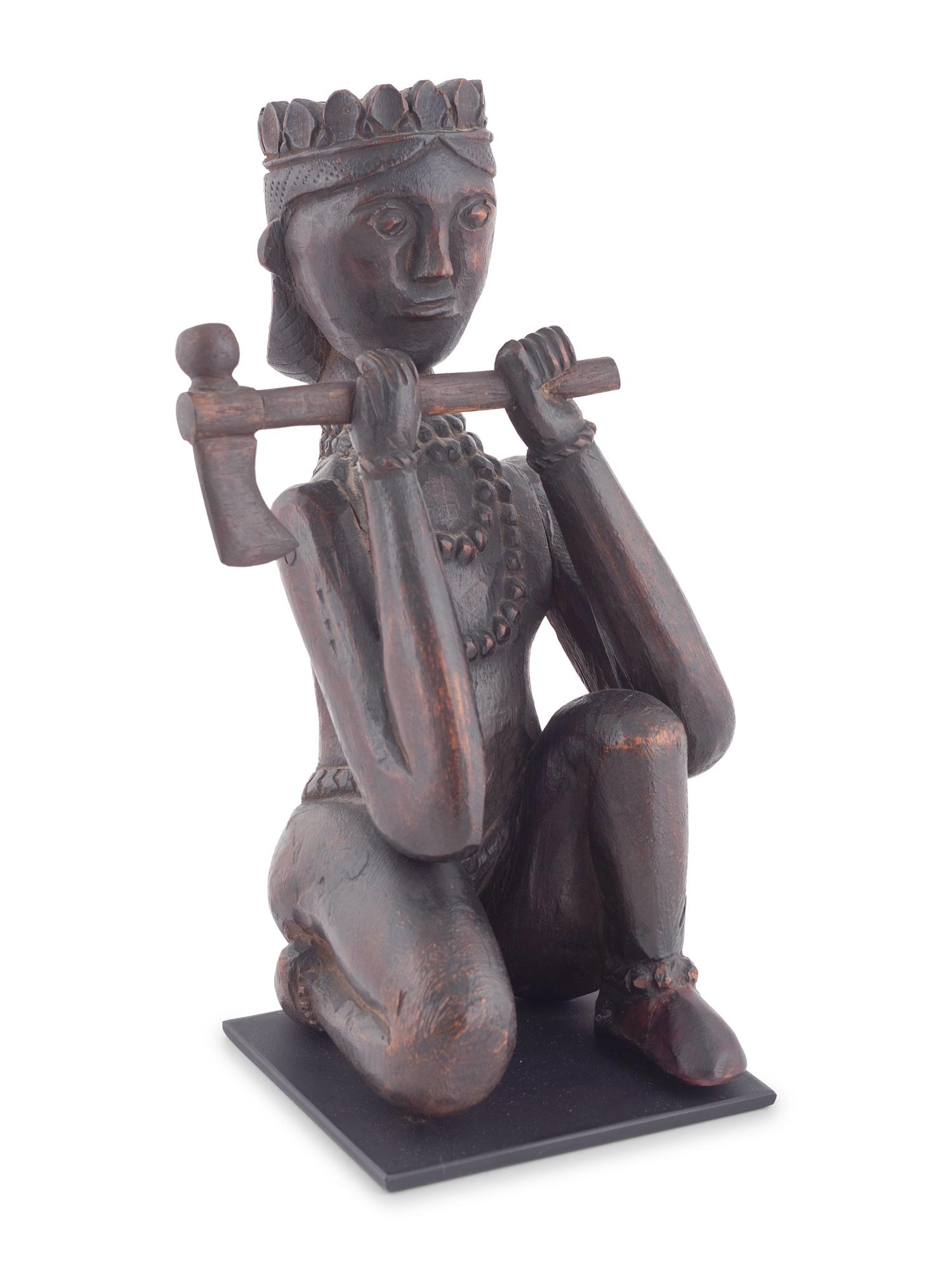 A Seated Folk Art Carved Walnut Indian with Tomahawk