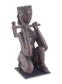 A Seated Folk Art Carved Walnut Indian with Tomahawk