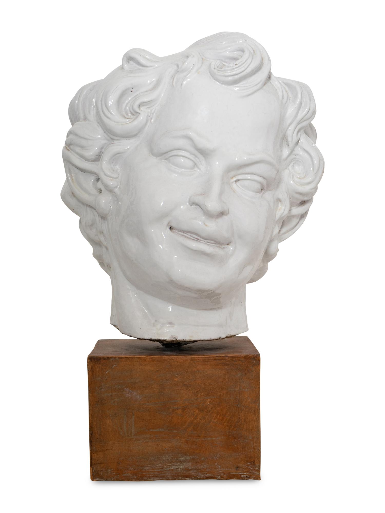 A Large White-Glazed Terracotta Bust on Ceramic Stand