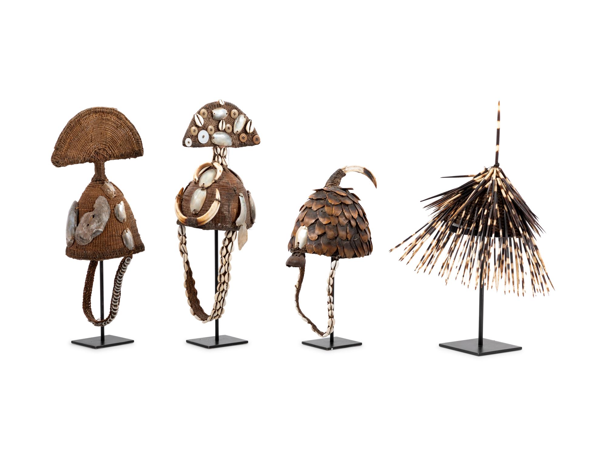 Seven Lega Headdresses and a Bamileke Quill Headdress