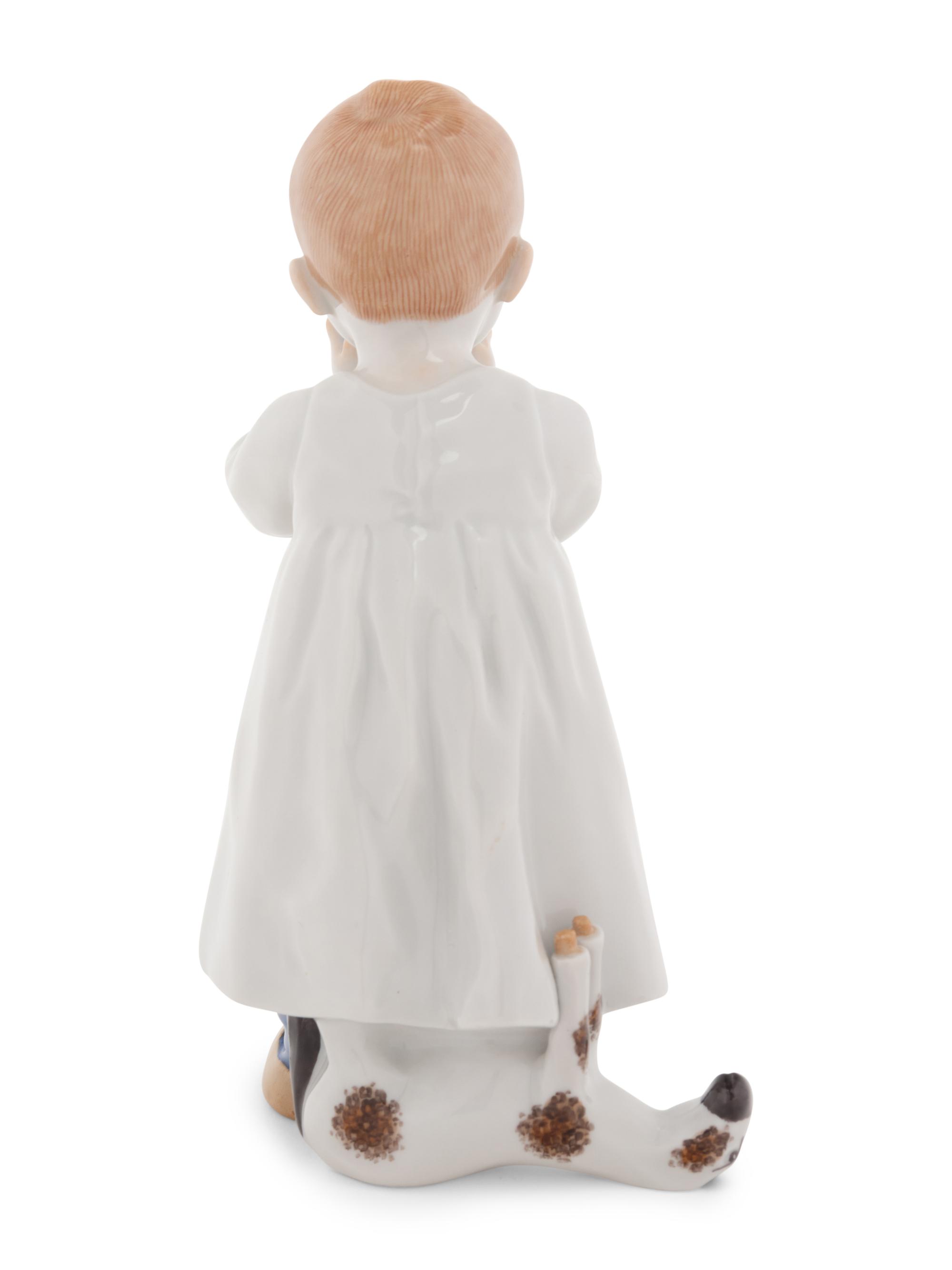 A Meissen Porcelain Figure of a Boy Drinking From a Blue Onion Bowl