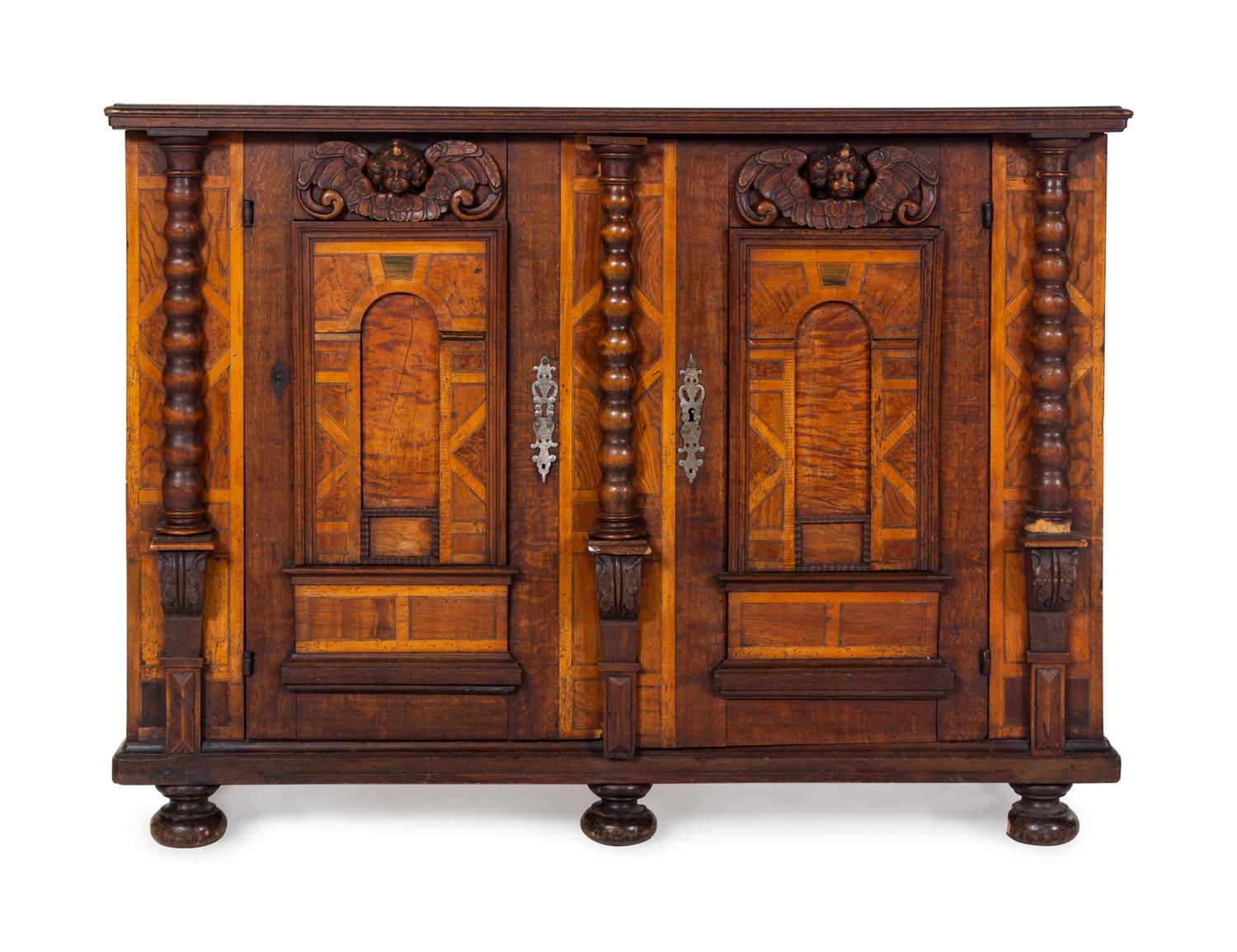 A German Carved Walnut and Parquetry Cabinet