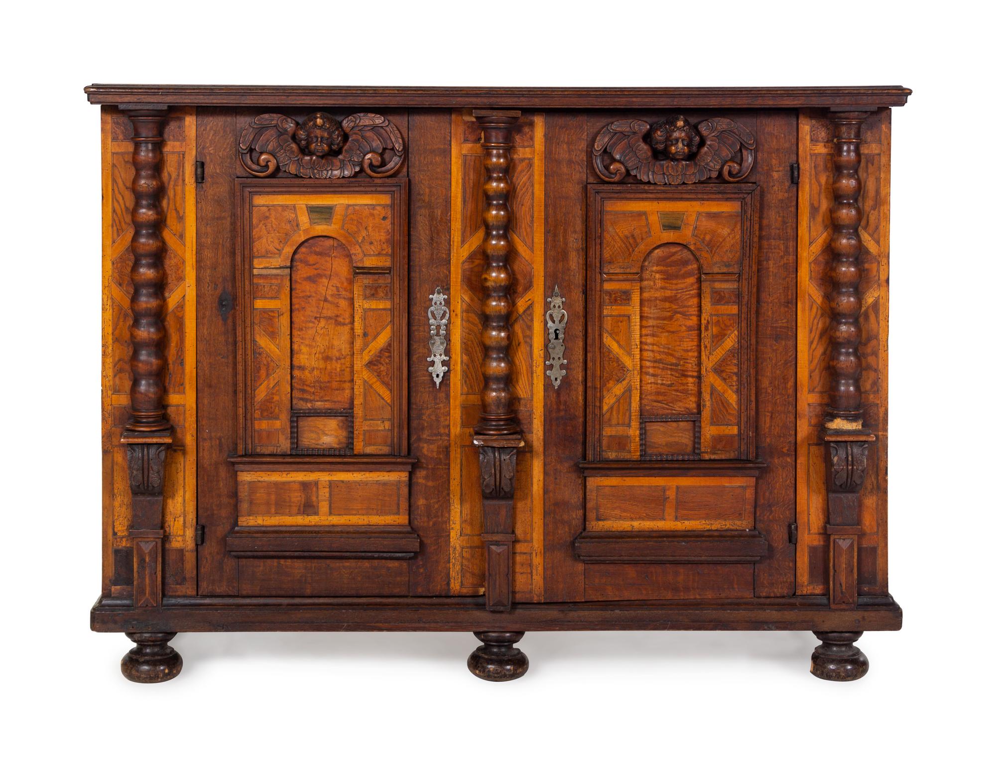 A German Carved Walnut and Parquetry Cabinet