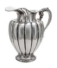 A South American Water Pitcher, Likely Peruvian, 20th Century, of baluster form, having an acanthus capped handle and a lobed body.