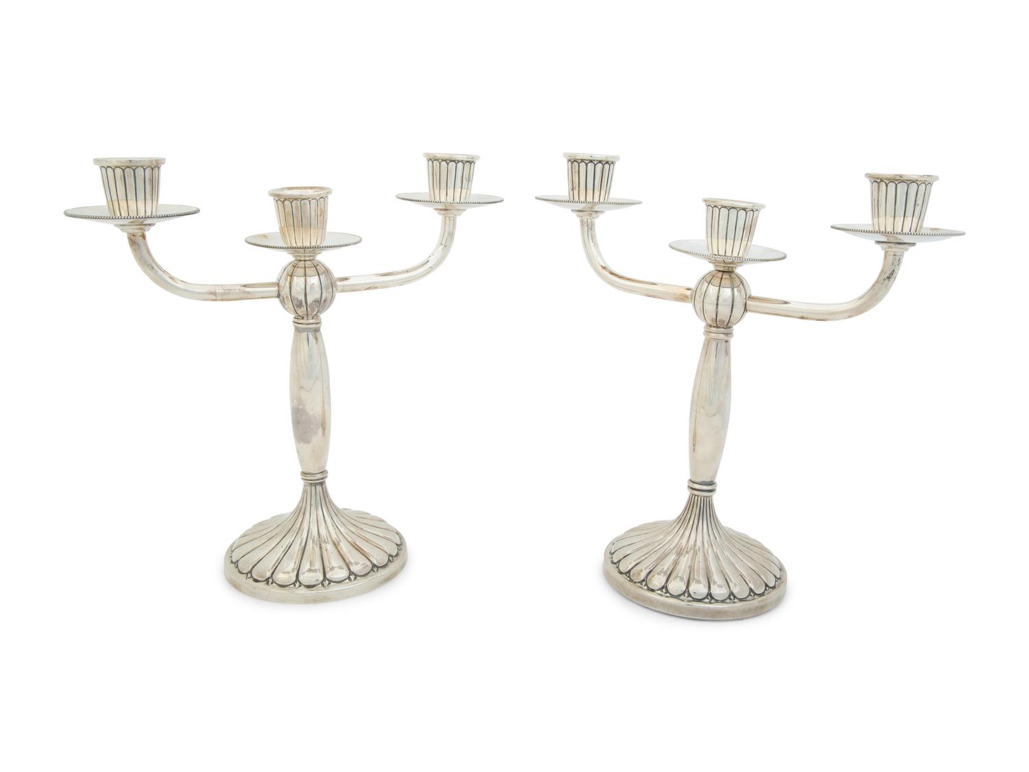 A Pair of Argentine Weighted Silver Three-Light Candelabra