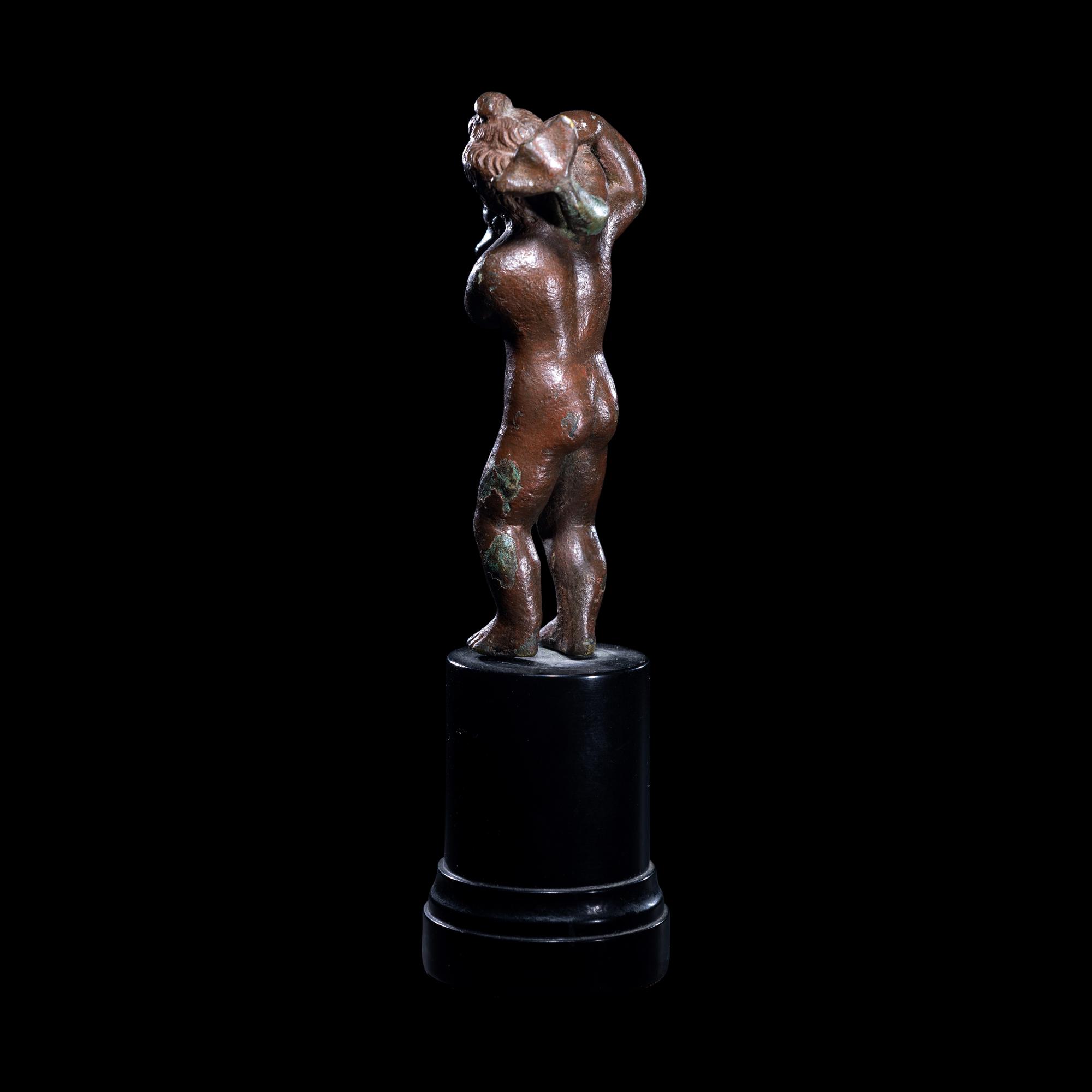 A Roman Bronze Eros with a Dolphin