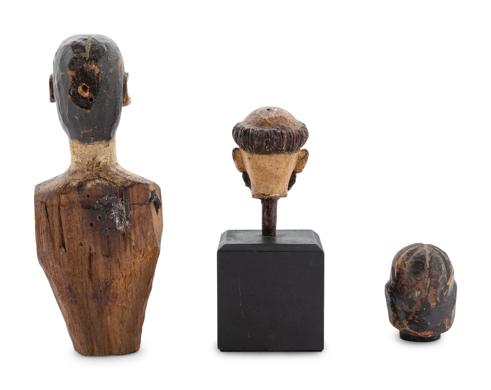 A Carved and Polychrome Painted Santos Heads