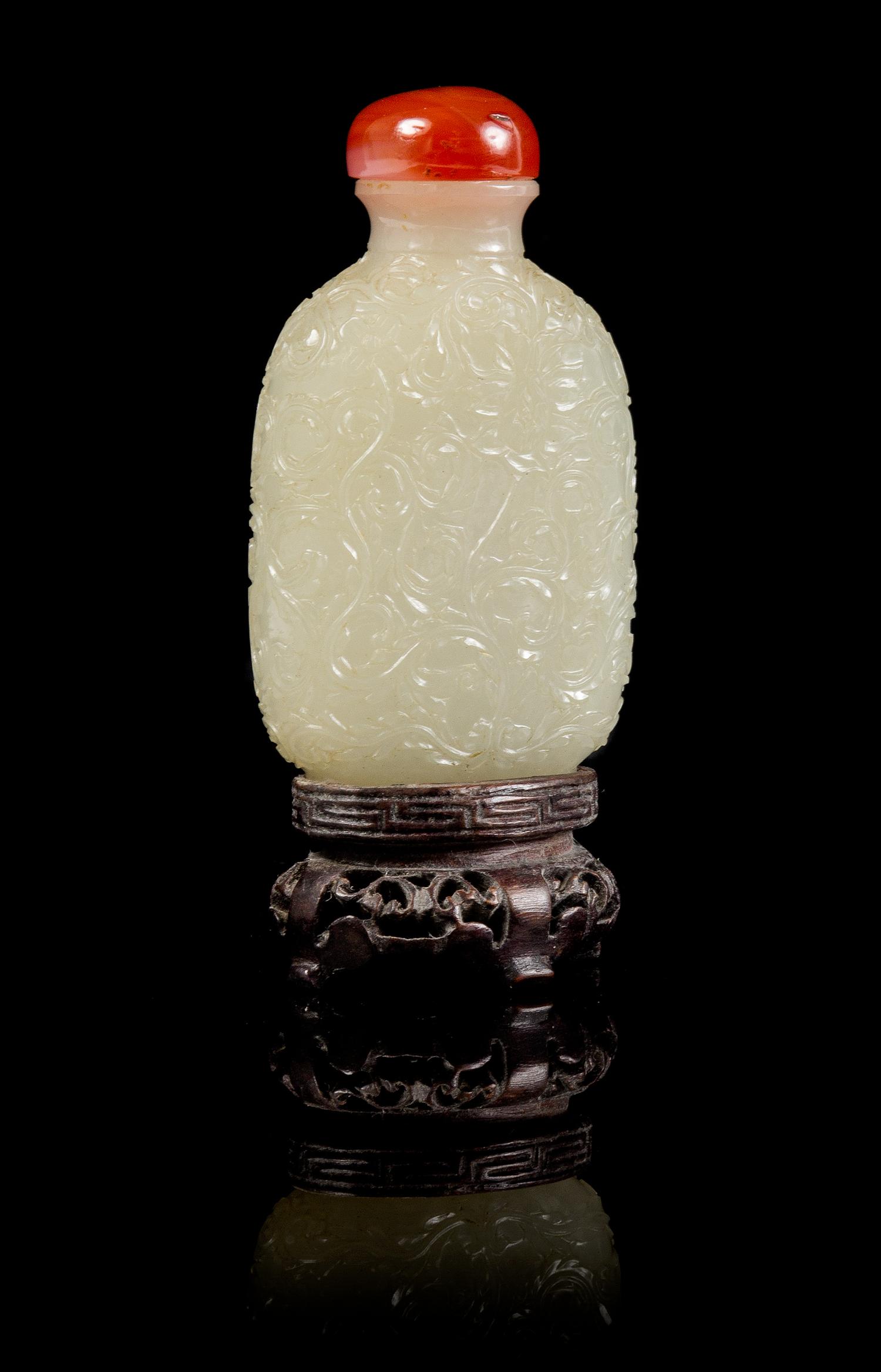 A Carved Jade Snuff Bottle Height 3 3/4 inches (with stand).