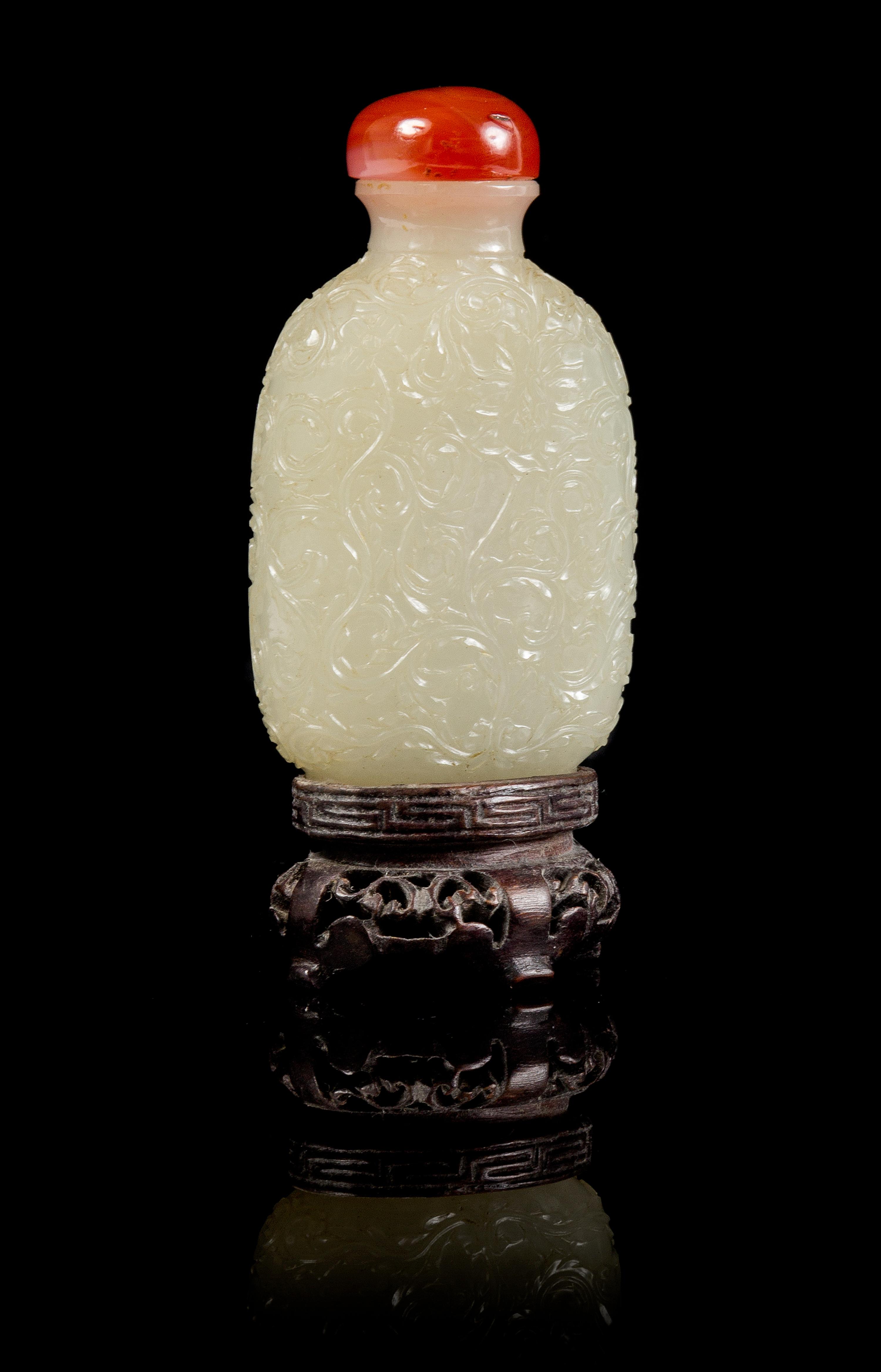 A Carved Jade Snuff Bottle Height 3 3/4 inches (with stand).