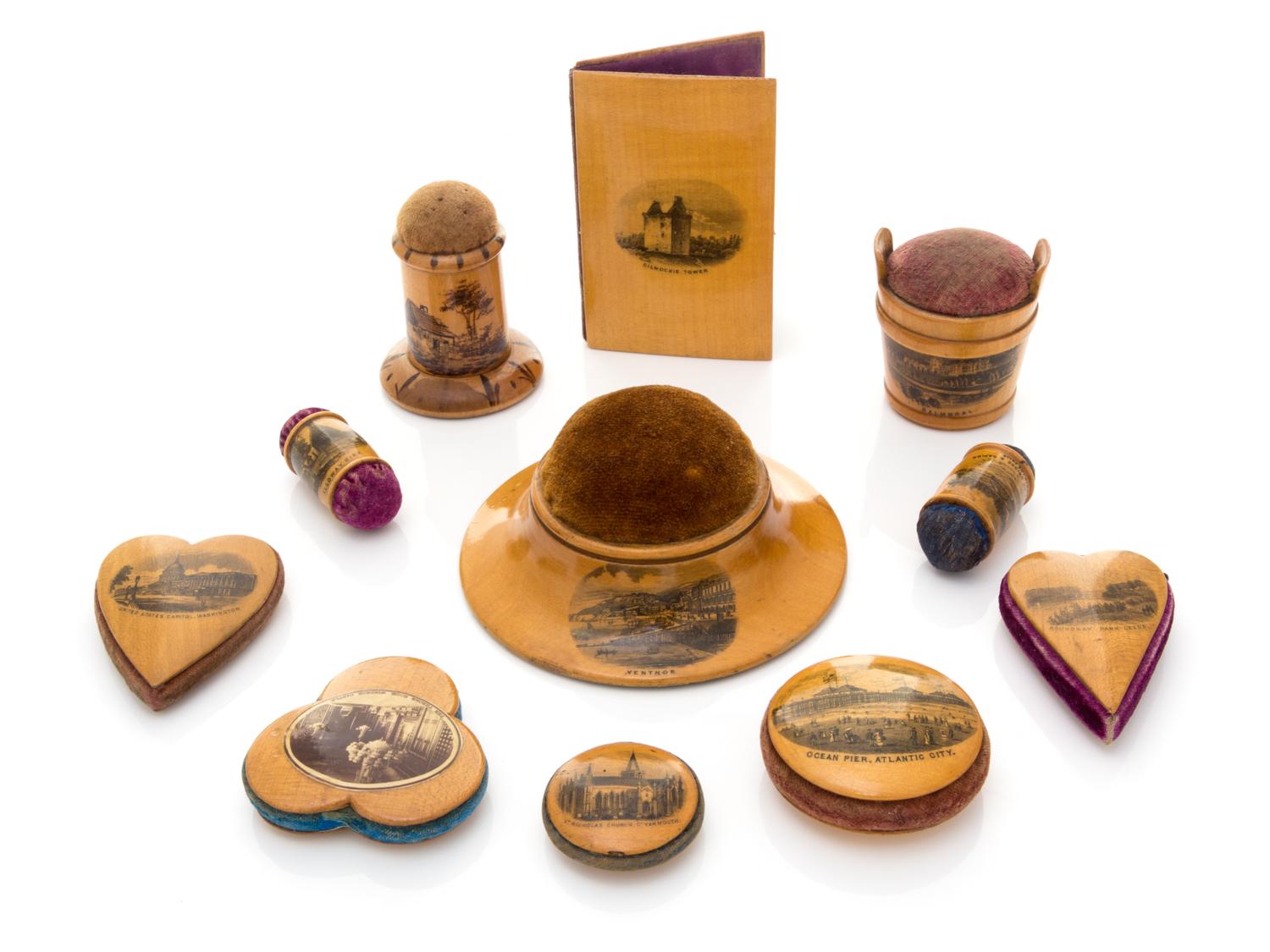 Eleven Mauchline Ware Pin Cushions Diameter of largest 4 inches.