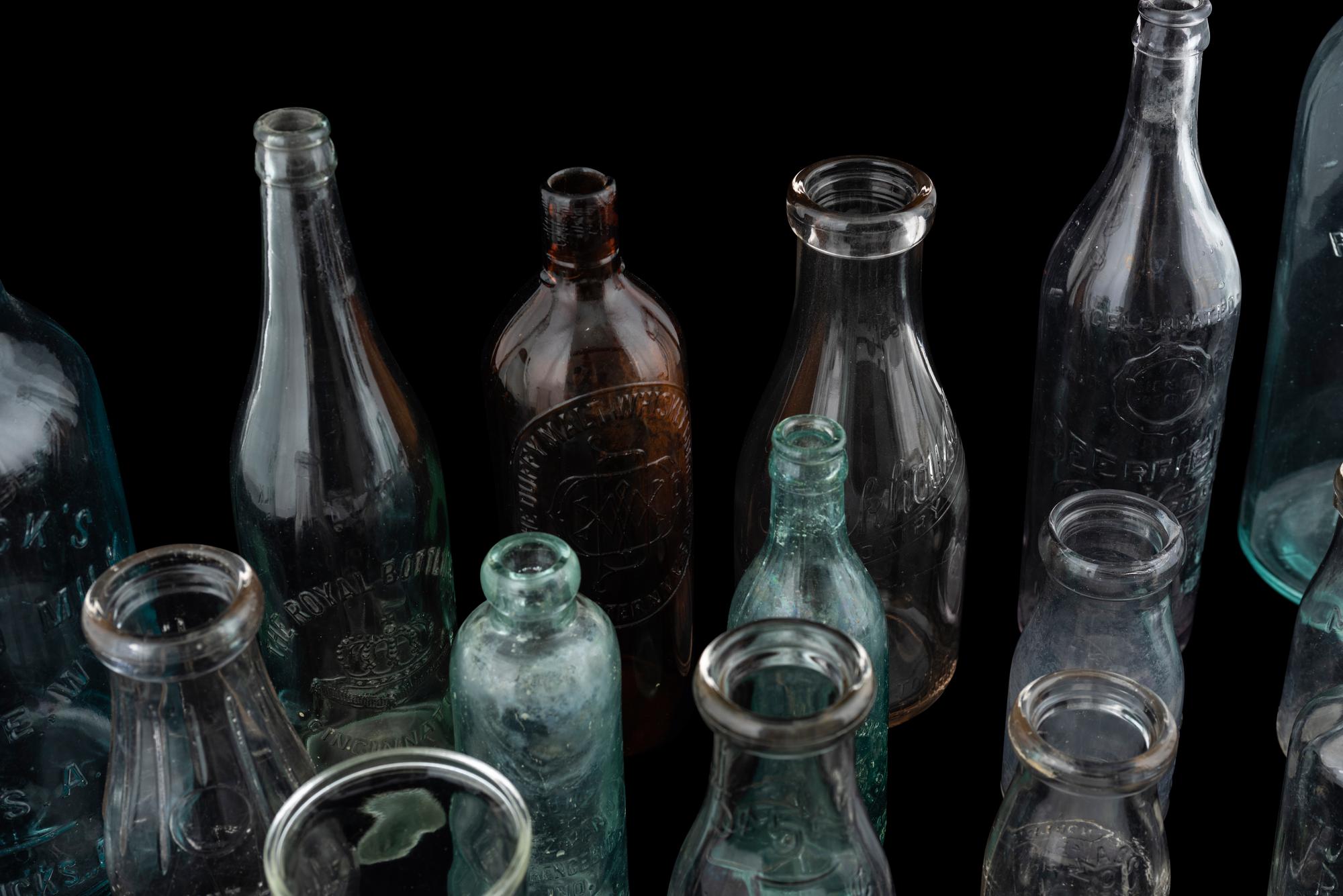 Sixteen Glass Advertising Bottles