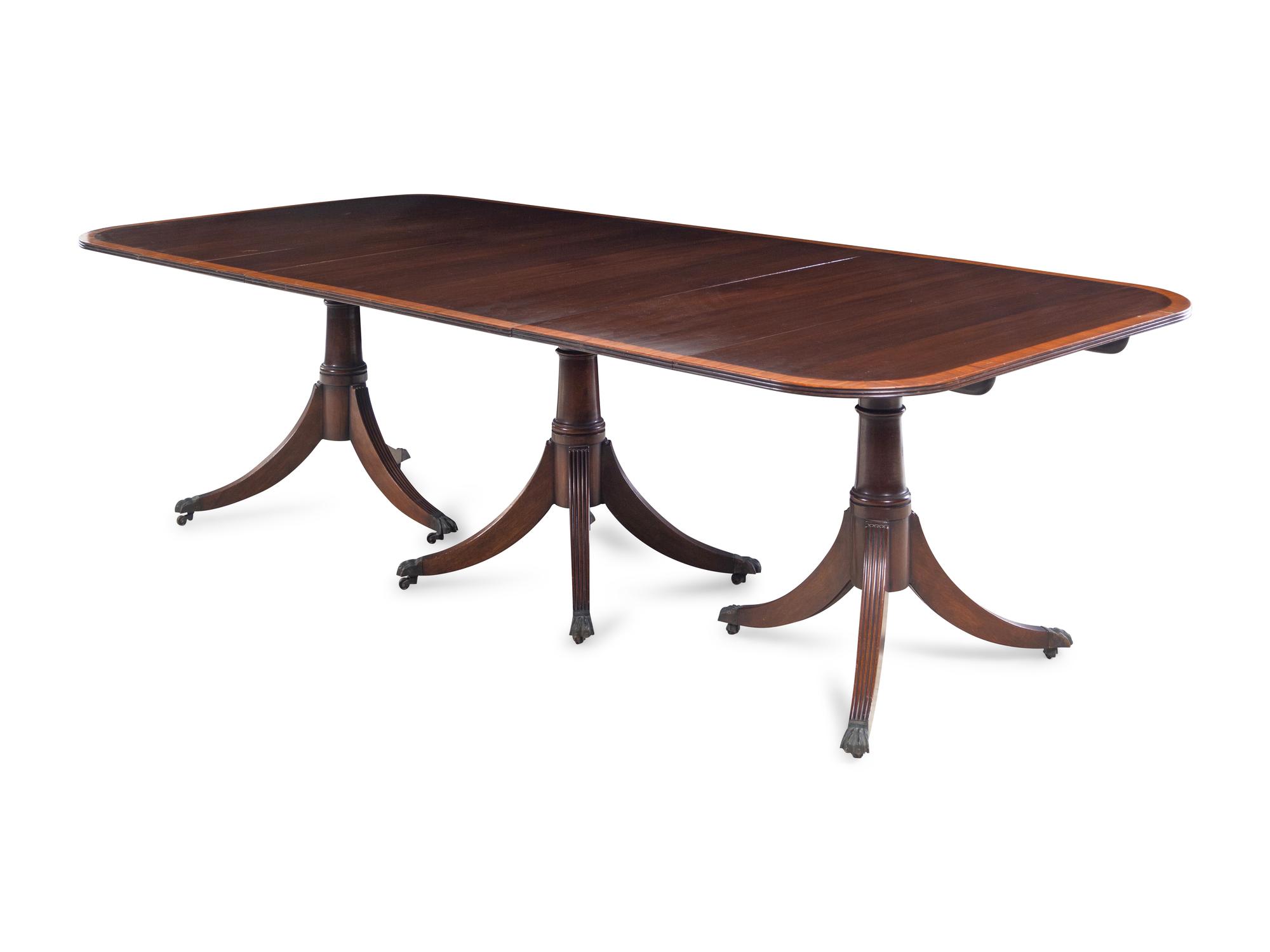 A Regency Style Satinwood Banded Mahogany Triple-Pedestal Dining Table