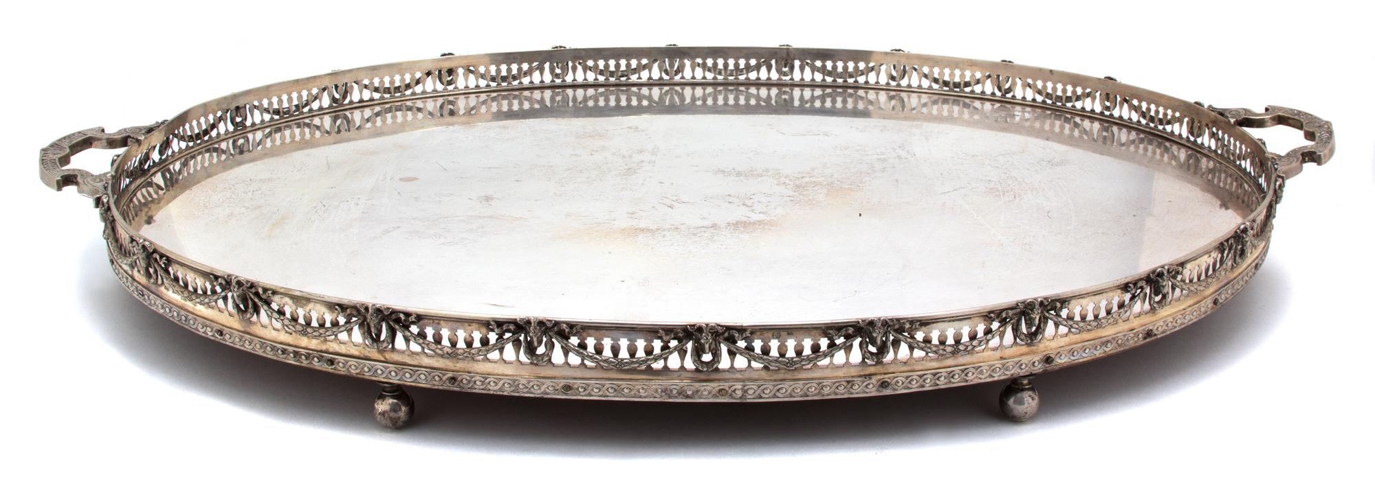 A Continental Silver Two-Handle Tray, 19TH CENTURY, having a pierced gallery, with goat's head and laurel swag decoration on a mahogany