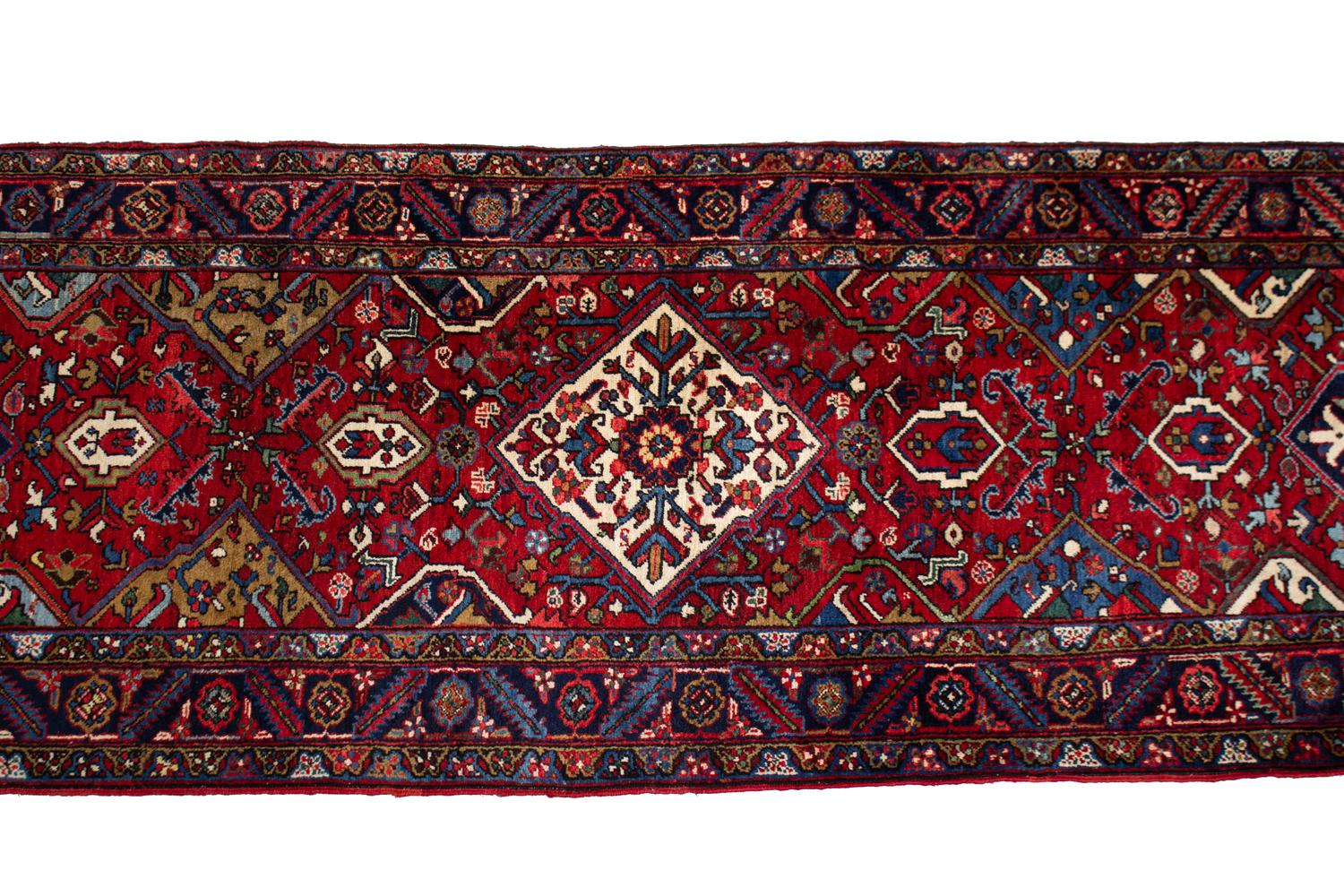 A Persian Wool Runner 19 feet 2 inches x 3 feet 5 inches. — 20TH CENTURY