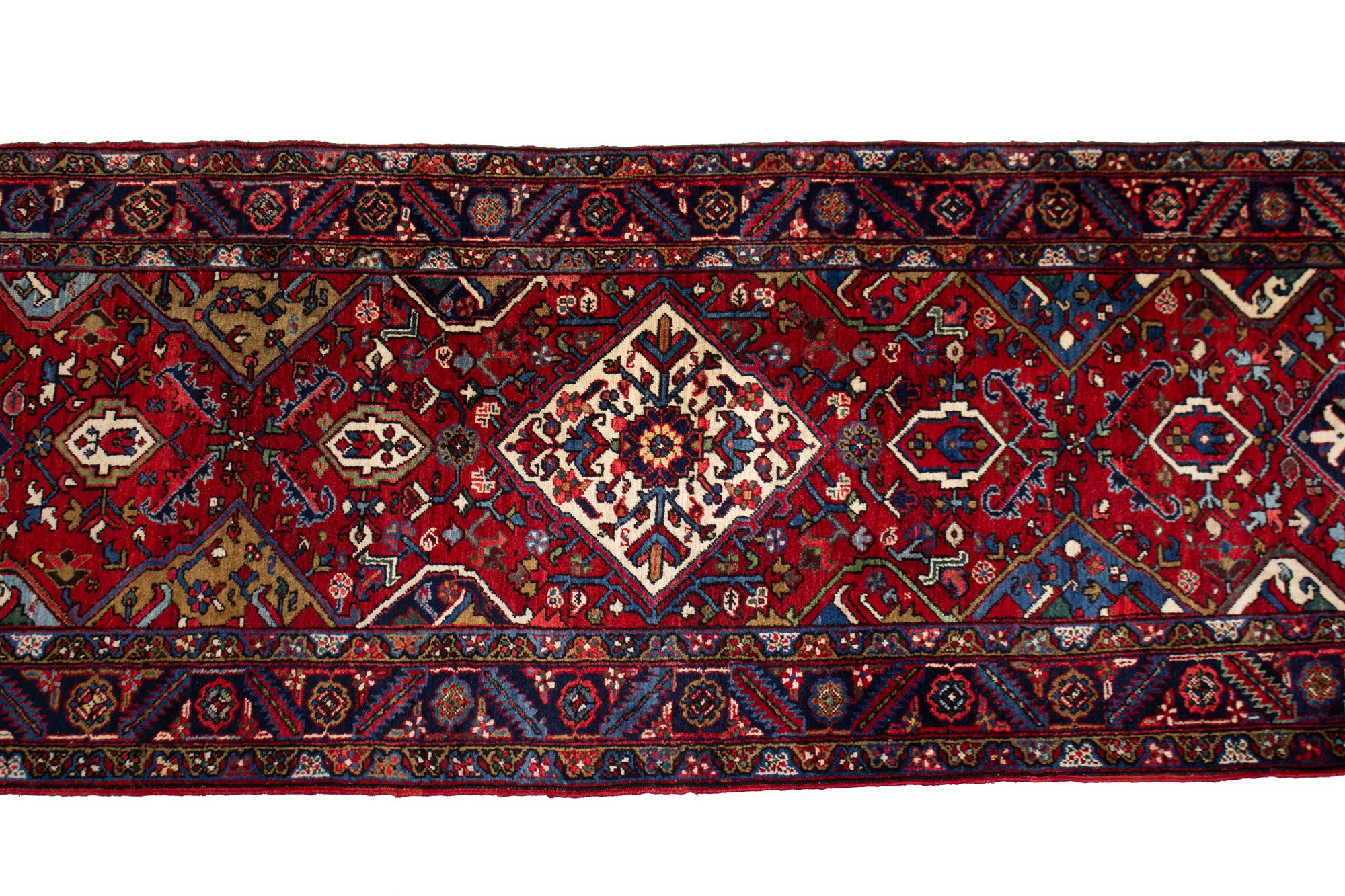 A Persian Wool Runner 19 feet 2 inches x 3 feet 5 inches. — 20TH CENTURY