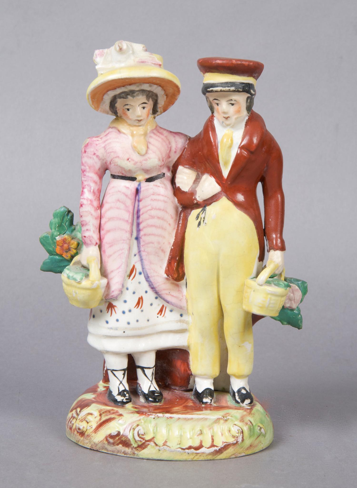 A Staffordshire Figural Group, Height 7 inches.