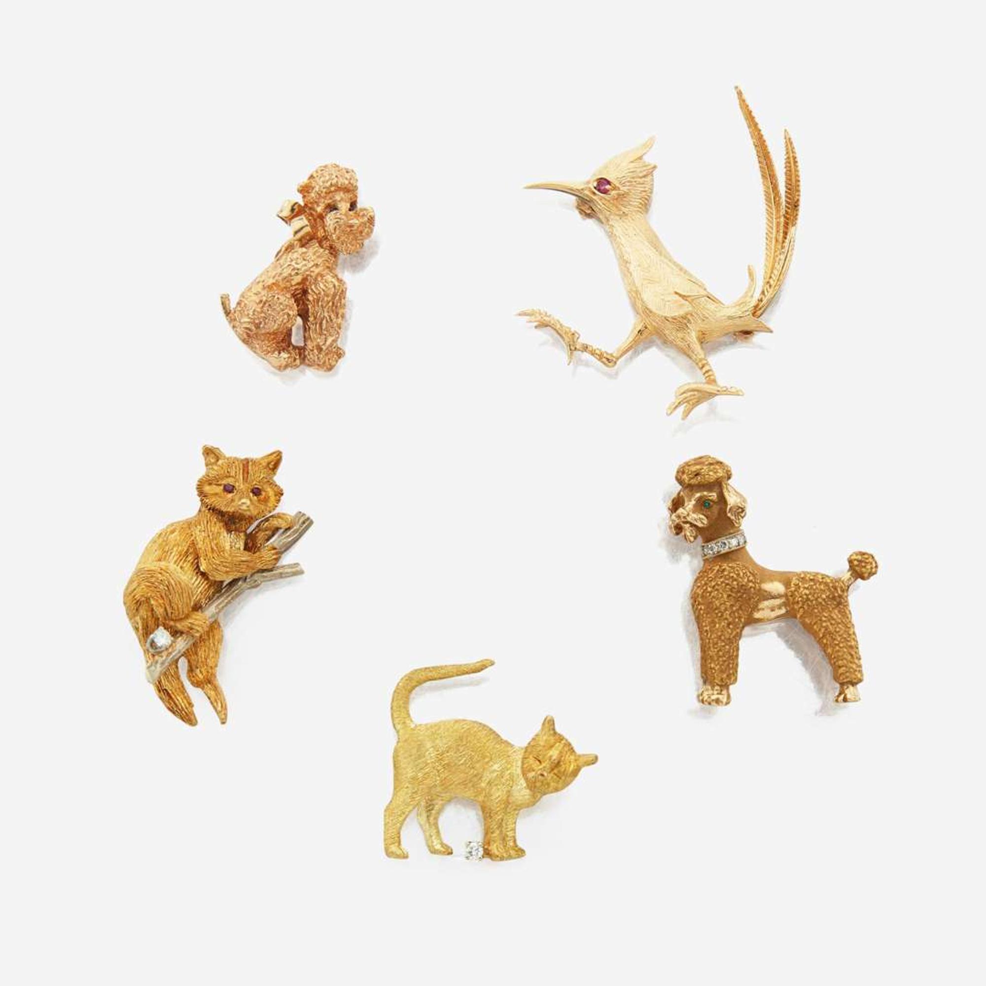 A collection of five gold and gem-set brooches