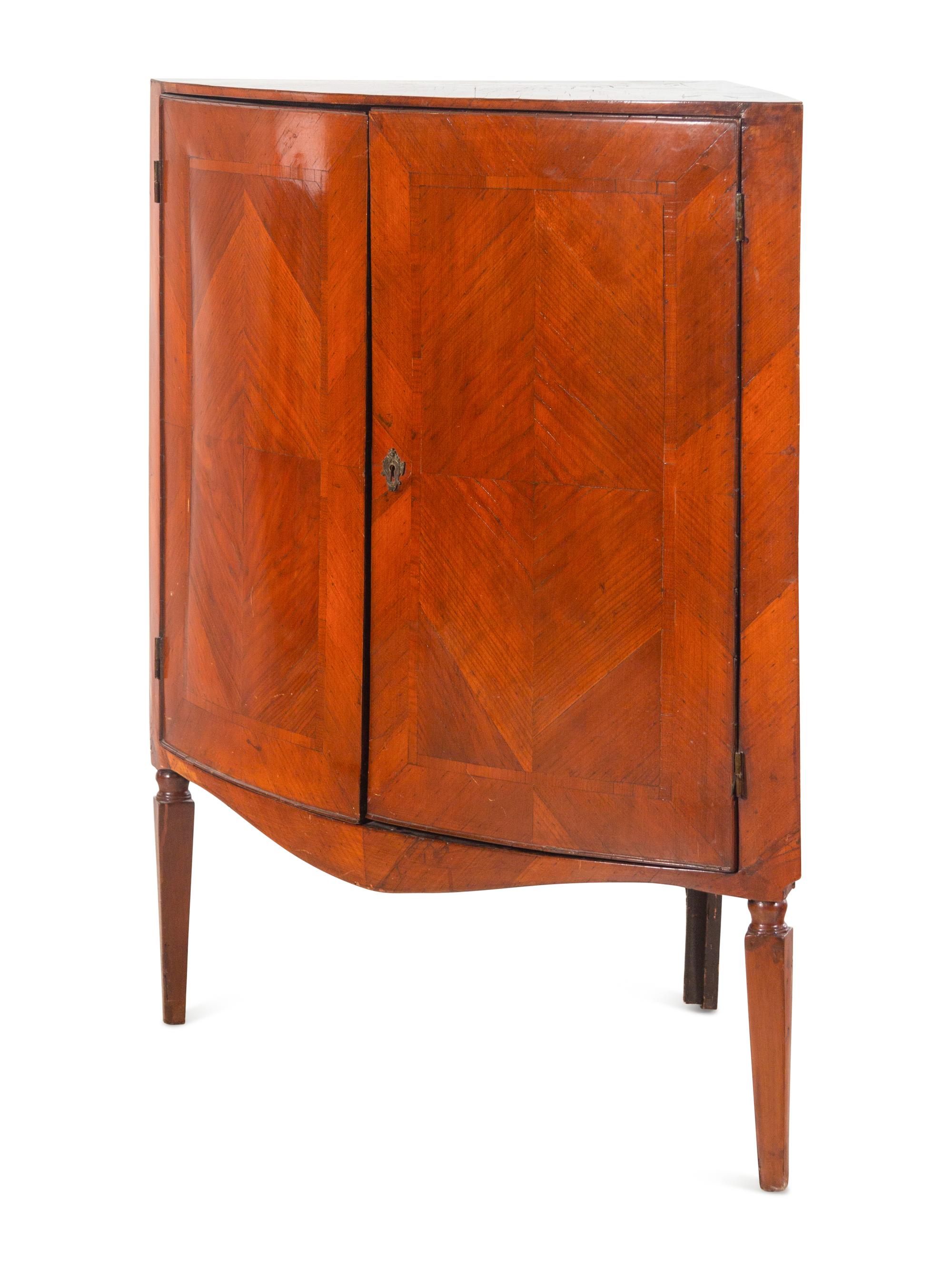 A Continental Bookmatch Veneered Corner Cabinet