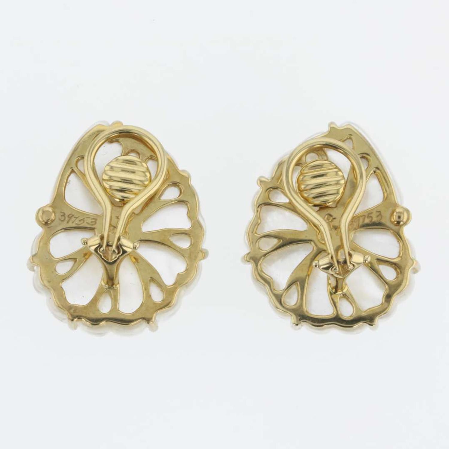 A pair of 18K yellow gold, rock crystal, and blue topaz ear clips, Trianon Nautilus