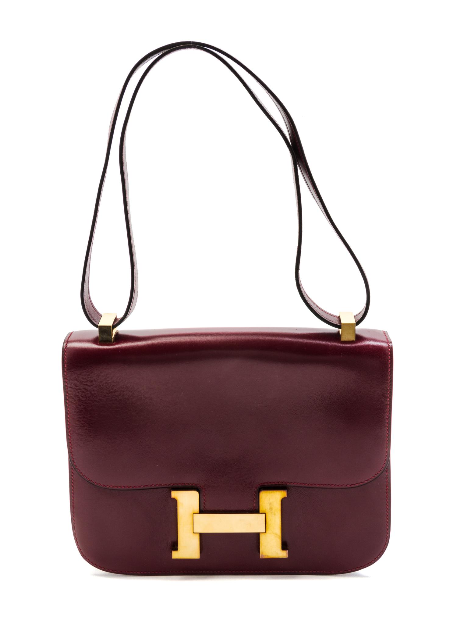 An Hermes 23cm Rouge Leather Constance Bag, 9 x 7 x 2 inches.