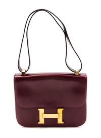 An Hermes 23cm Rouge Leather Constance Bag, 9 x 7 x 2 inches.