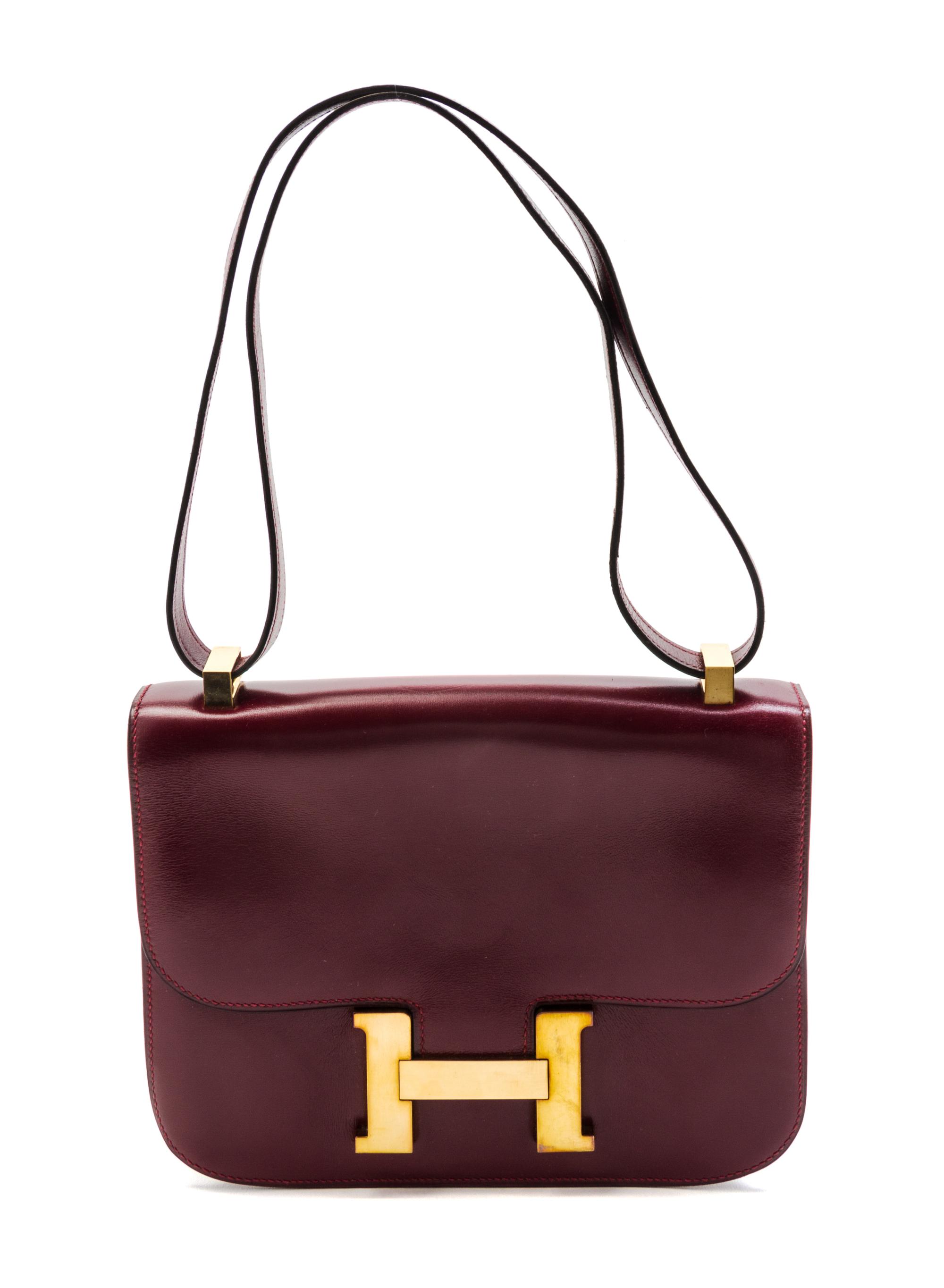 An Hermes 23cm Rouge Leather Constance Bag, 9 x 7 x 2 inches.