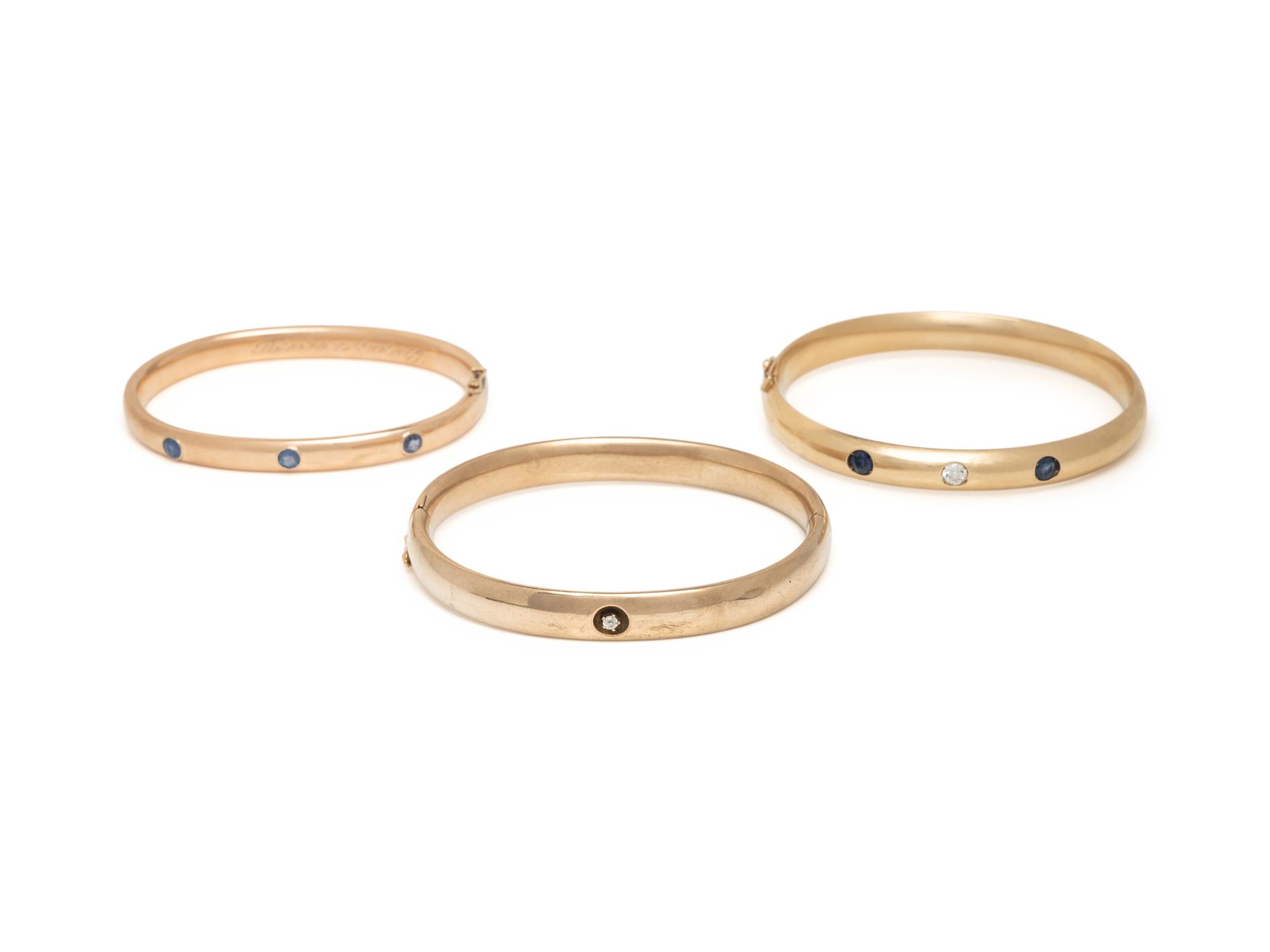 COLLECTION OF YELLOW GOLD, SAPPHIRE, AND DIAMOND BANGLE BRACELETS