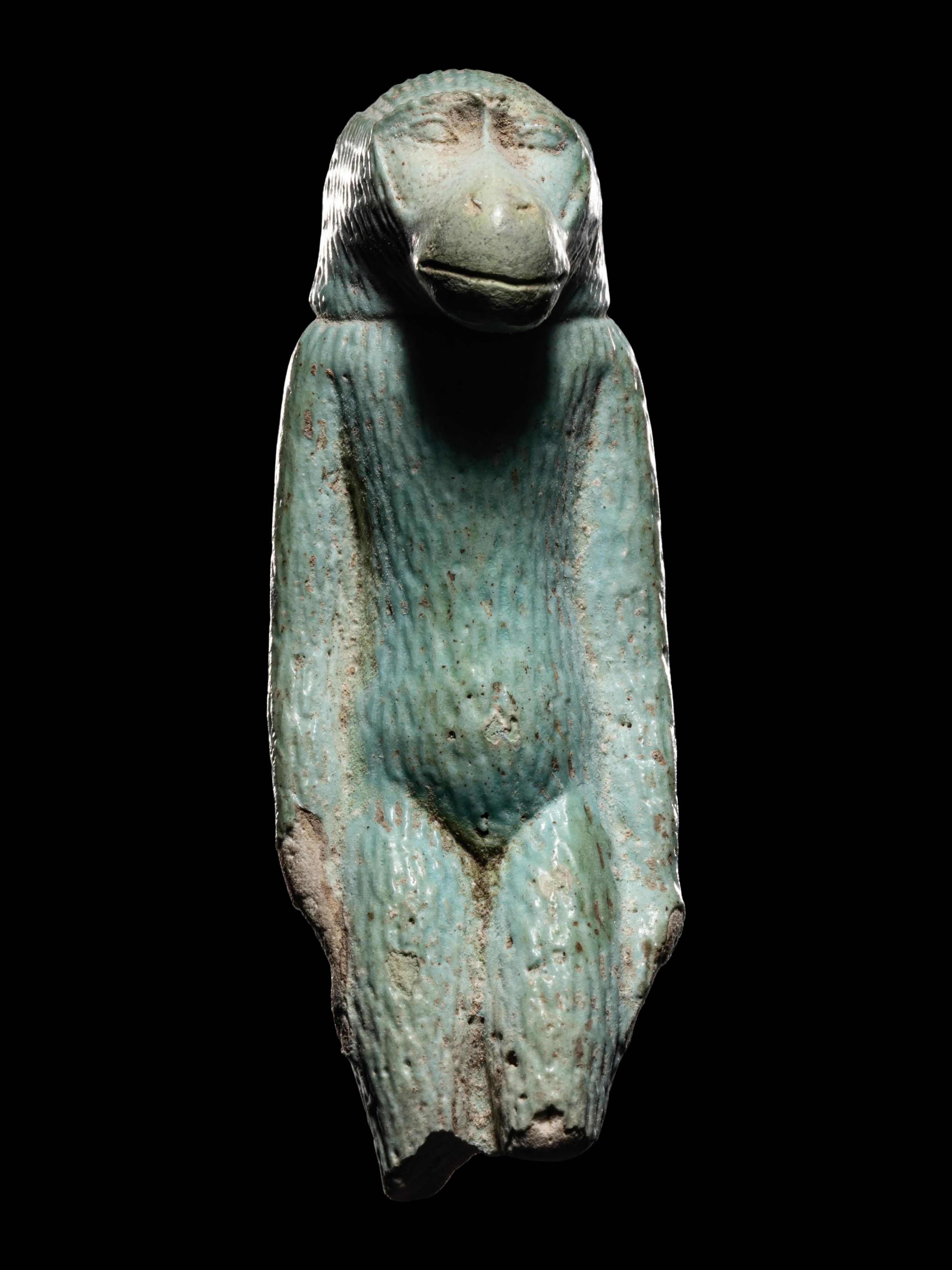 An Egyptian Faience Standing Ape