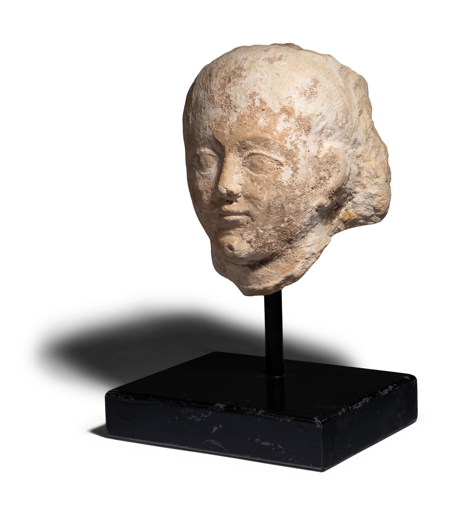 An Egyptian Limestone Head of a Boy