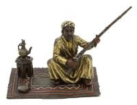 Nam Greb (Franz Bergmann), (Austrian, 1861-1936), Man with a Gun Seated on Rug
