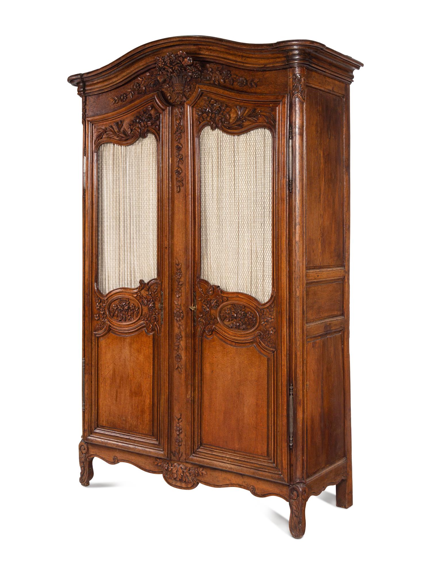 A Louis XV Provincial Style Carved Walnut Armoire