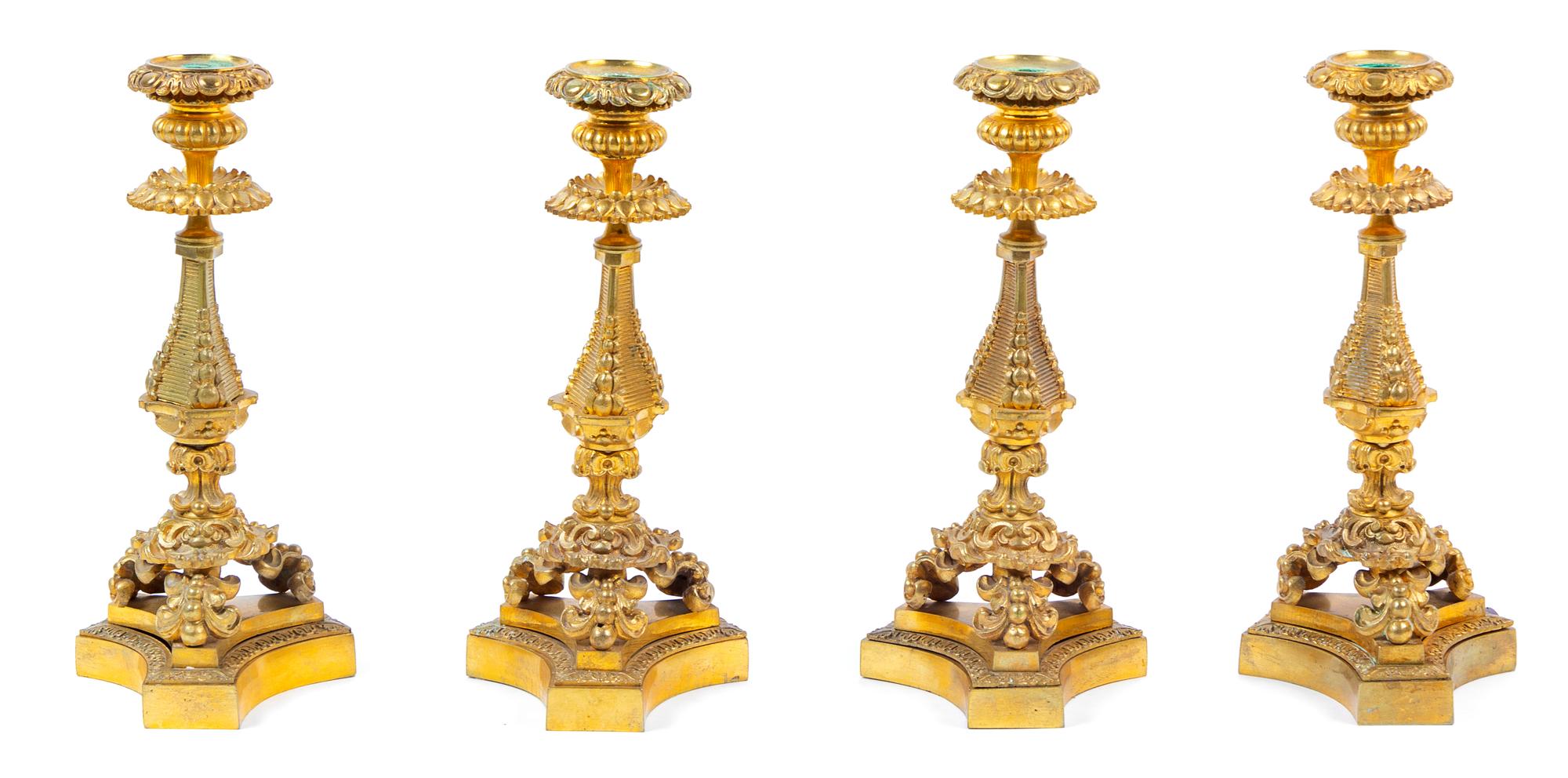 Four French Gilt Bronze Candlesticks Height 11 5/8 inches. — 19TH CENTURY