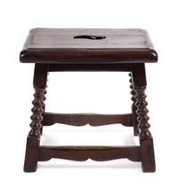 A Jacobean Style Walnut Stool Height 17 x width 17 1/2 x depth 14 inches.