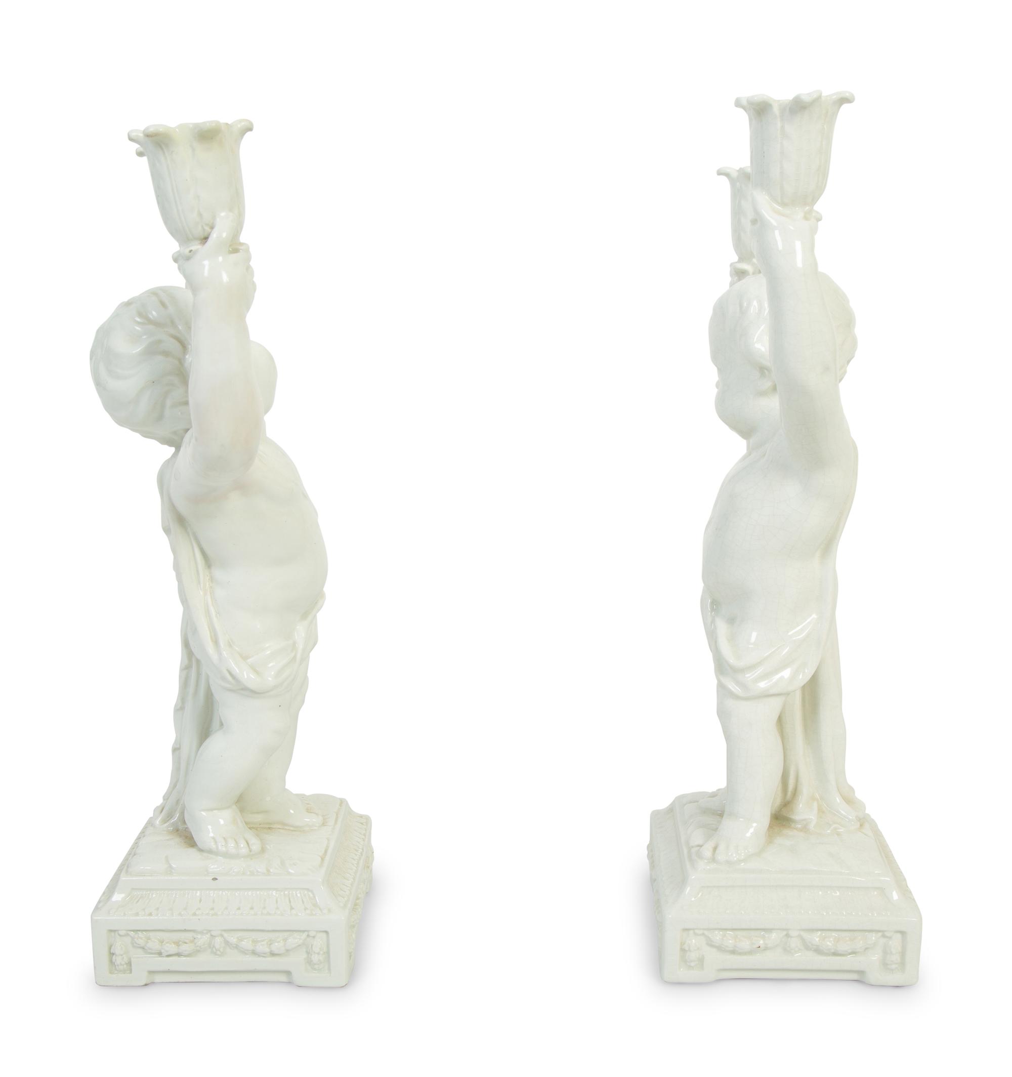 A Pair of Italian Creamware Figural Candelabra