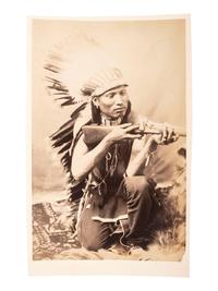 [NATIVE AMERICANS]. [BAKER & JOHNSTON, photographers]. Cabinet card of an Arapaho kneeling with rifle. [Evanston, Wyoming: ca 1890s].