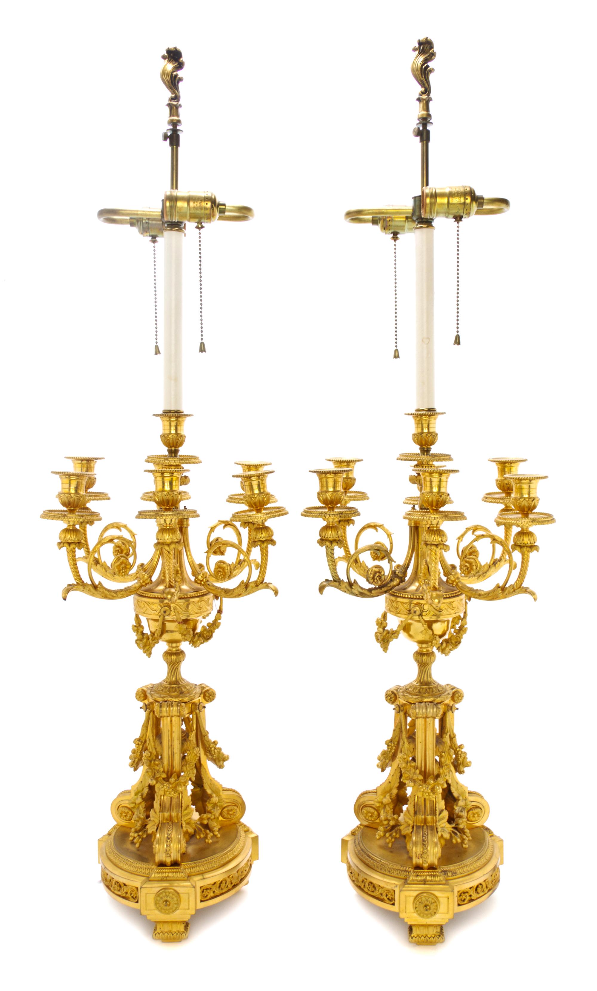 A Pair of Louis XVI Style Gilt Bronze Seven-Light Candelabra, Height 23 inches.