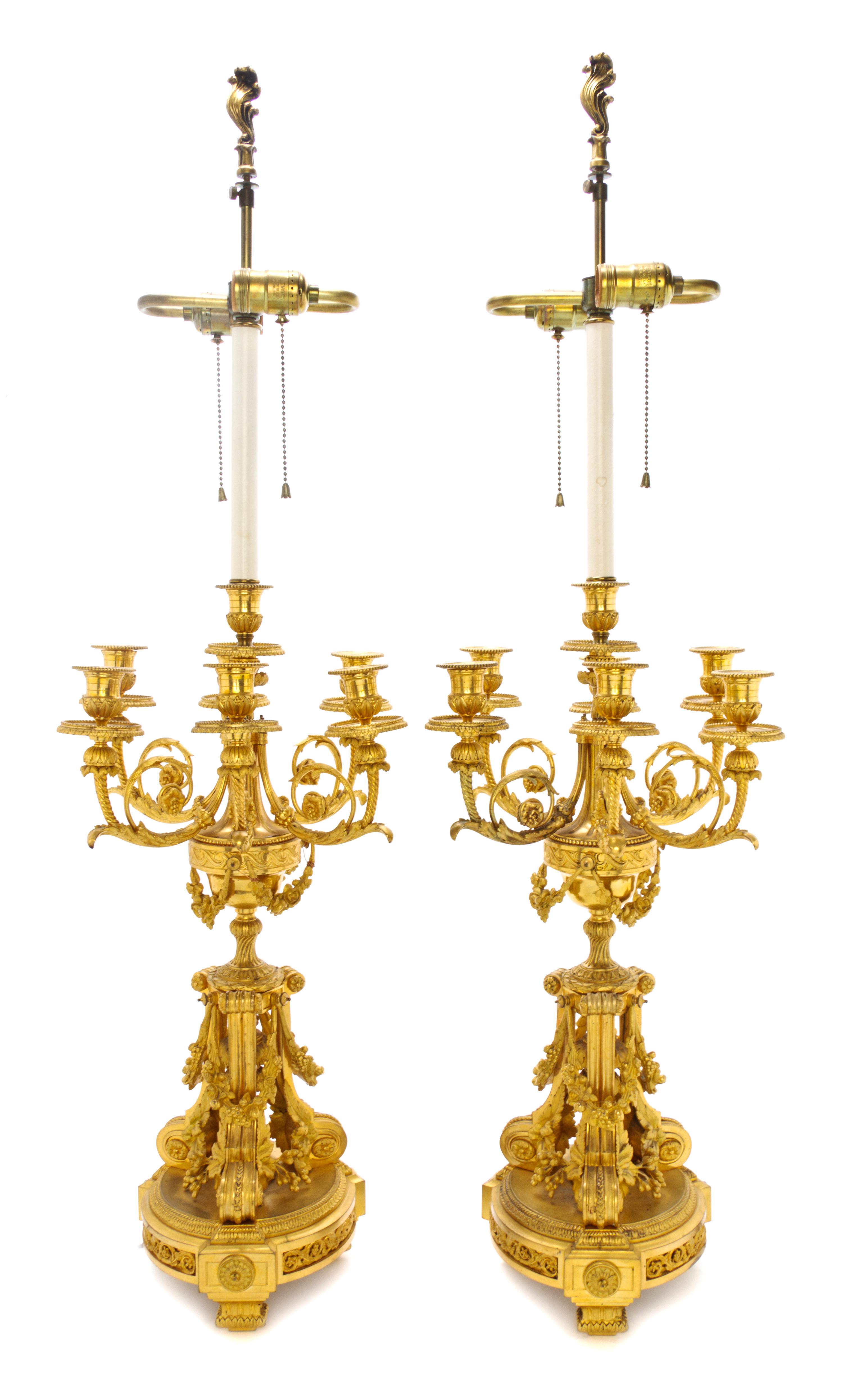 A Pair of Louis XVI Style Gilt Bronze Seven-Light Candelabra, Height 23 inches.